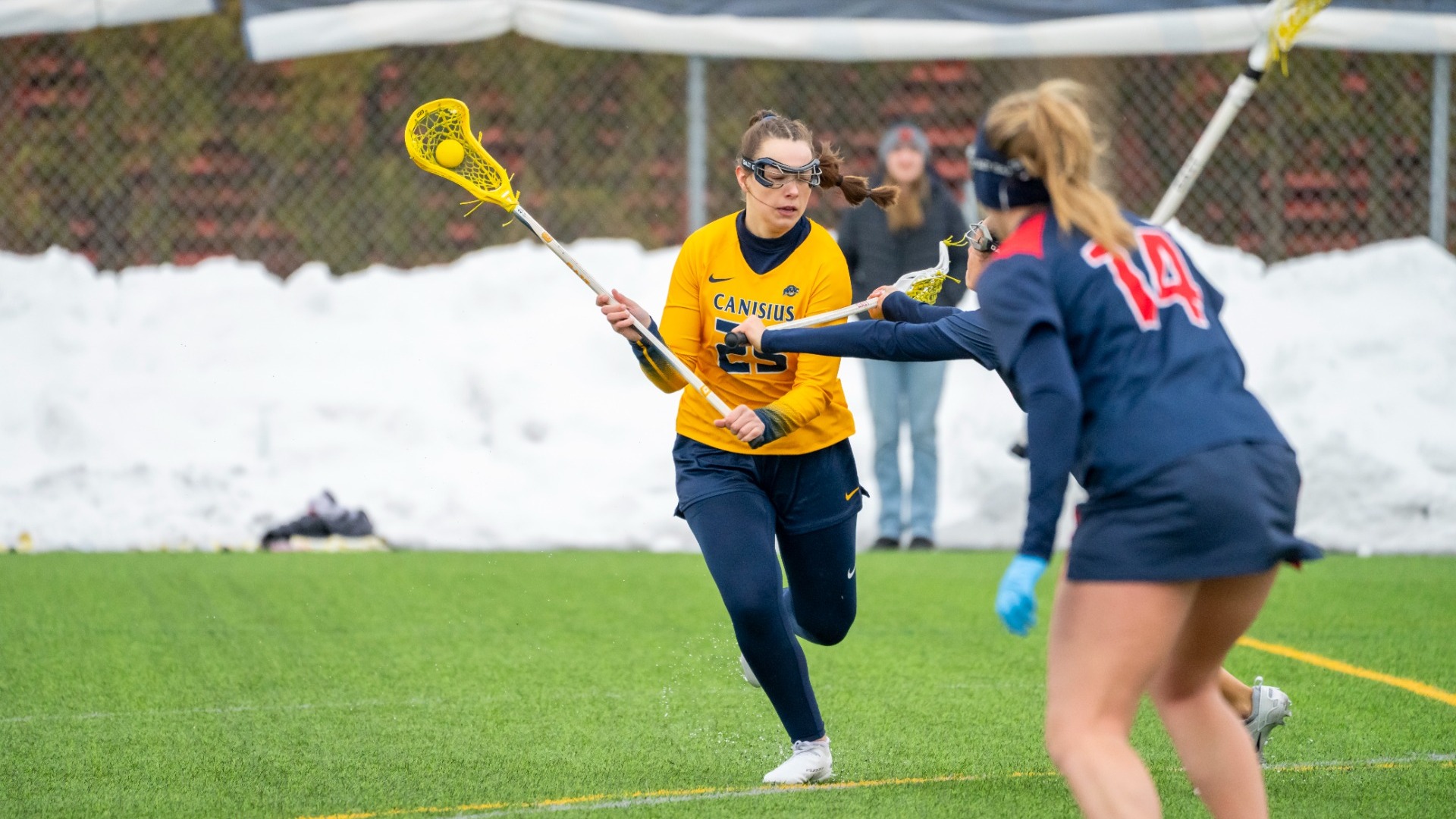 Katie Adams dekes a defender against Detroit Mercy at the Demske Sports Complex.