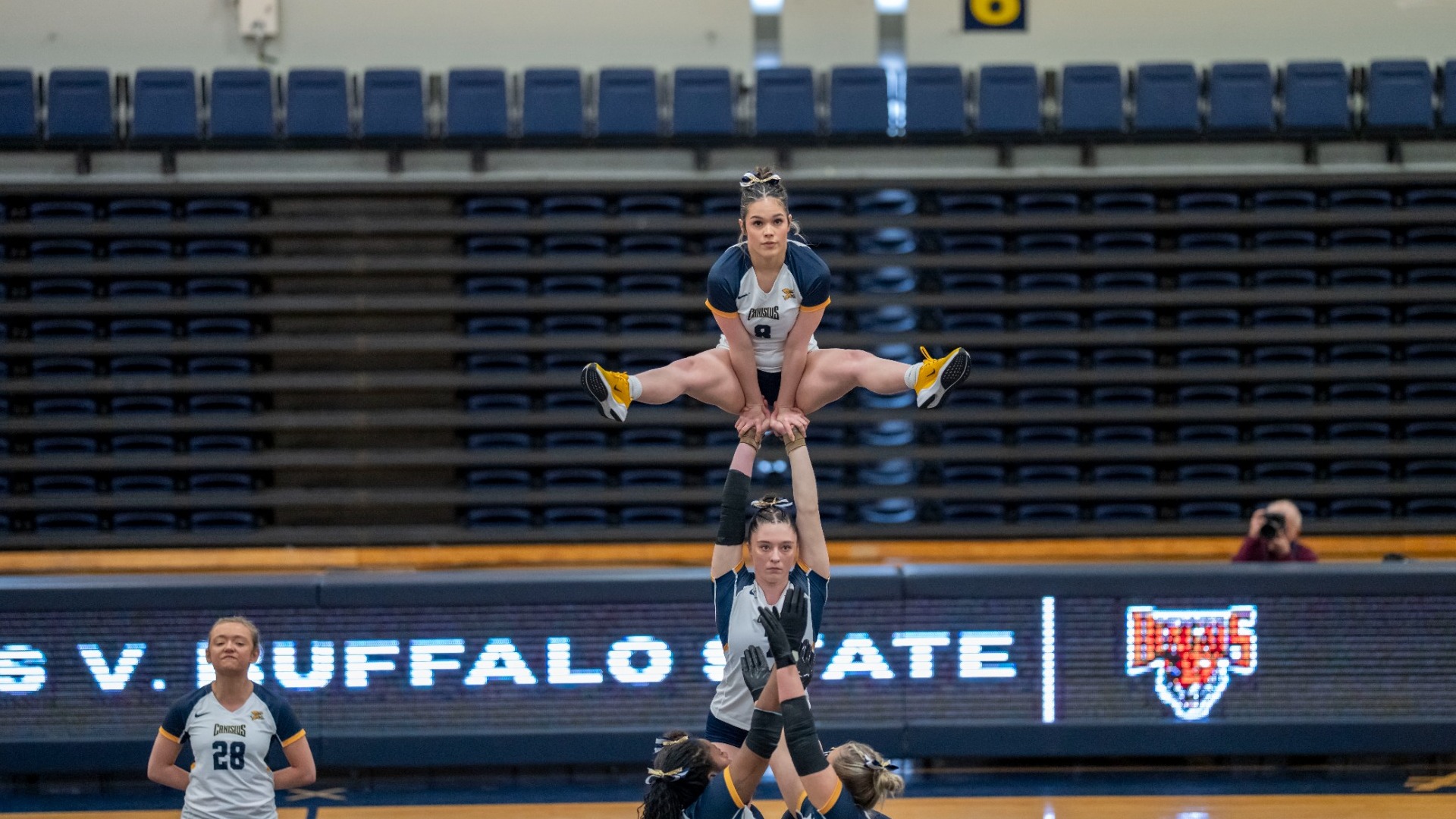 Eva Goode gets held up by teammates in inaugural meet against Buffalo State at the Koessler Athletic Center.