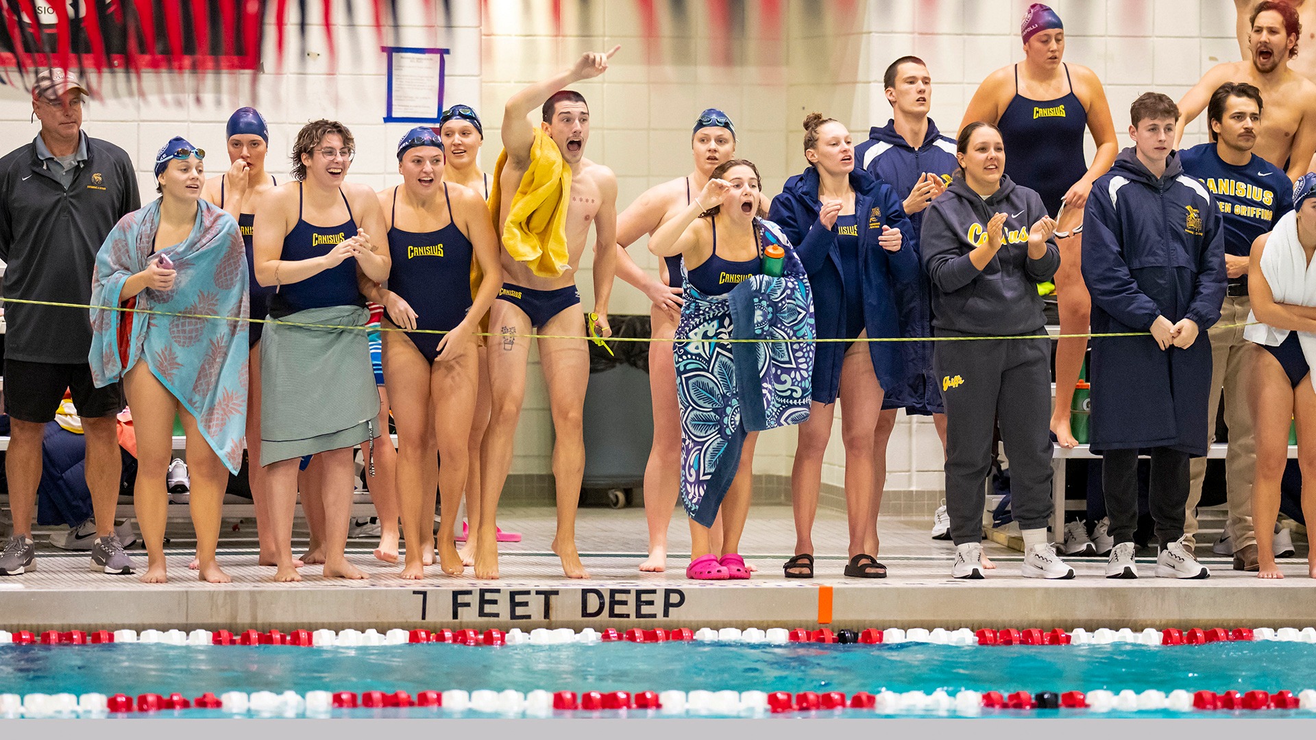 Members of the Canisius men's and women's swimming and diving programs cheer on their teammates during competition versus SUNY Geneseo at the Burt Flickinger Center in Buffalo on Oct. 24, 2025