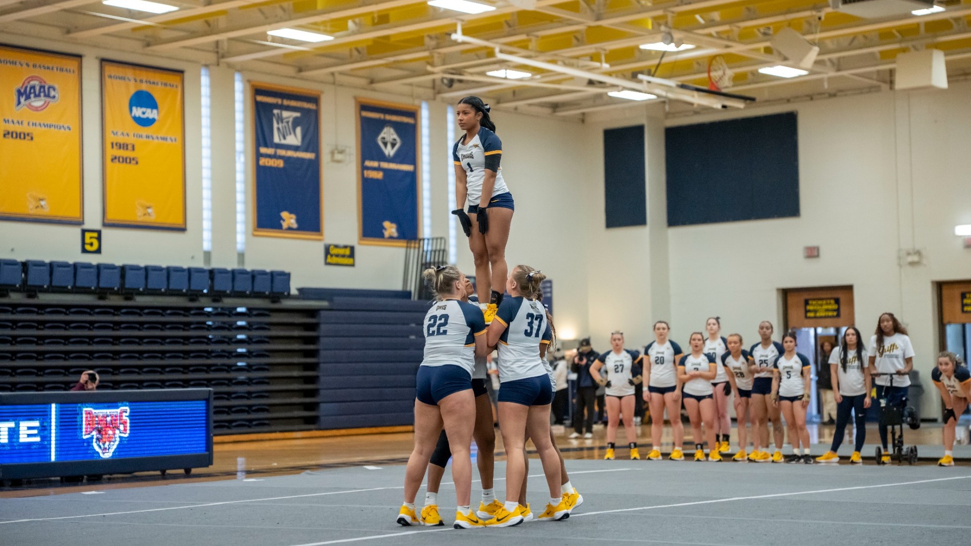 Aniyah Trippett held in air by teammates against Buffalo State in the Koessler Athletic Center.