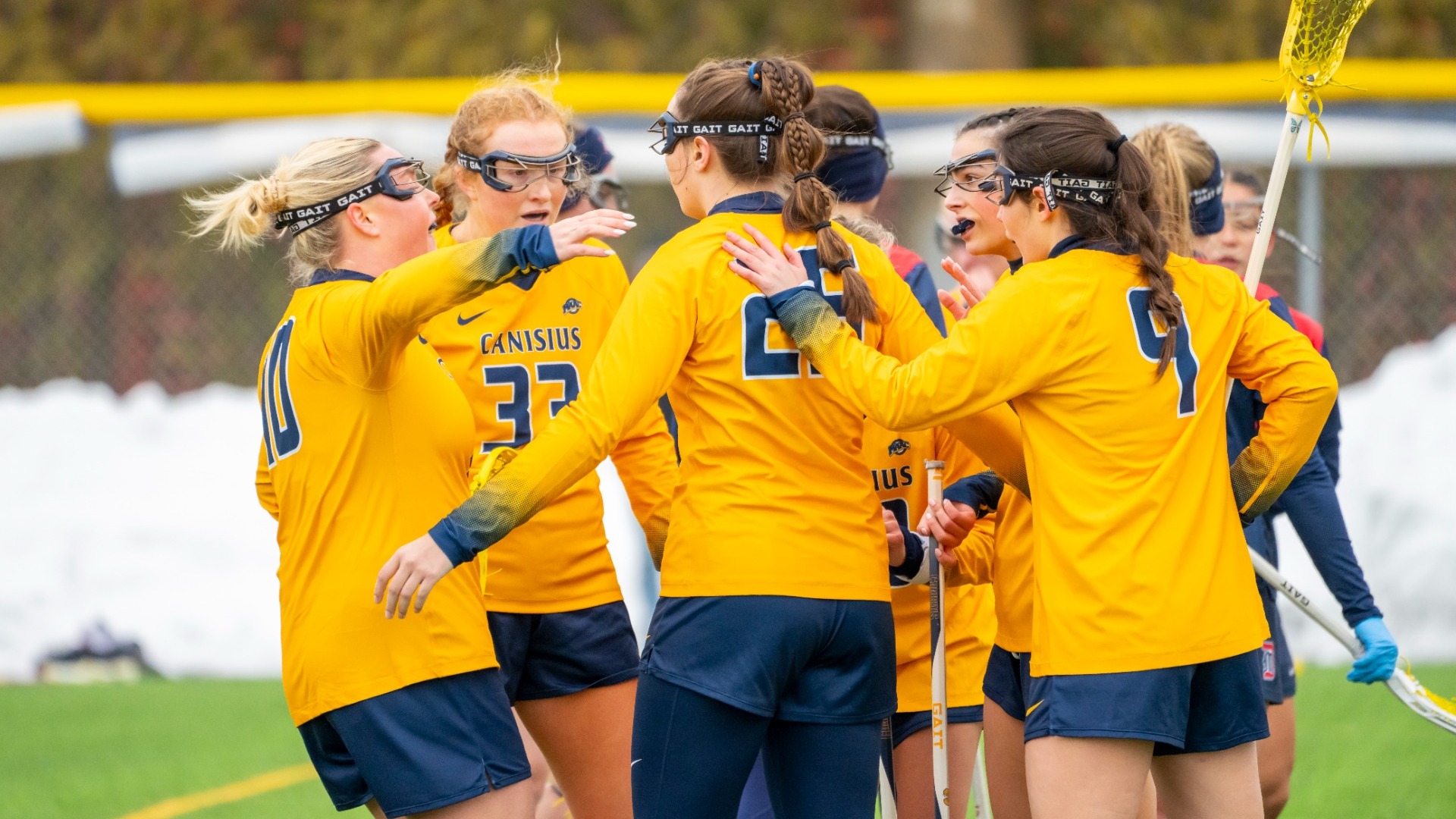 The women's lacrosse team celebrates a goal against Detroit Mercy at the Demske Sports Complex in Buffalo, N.Y.