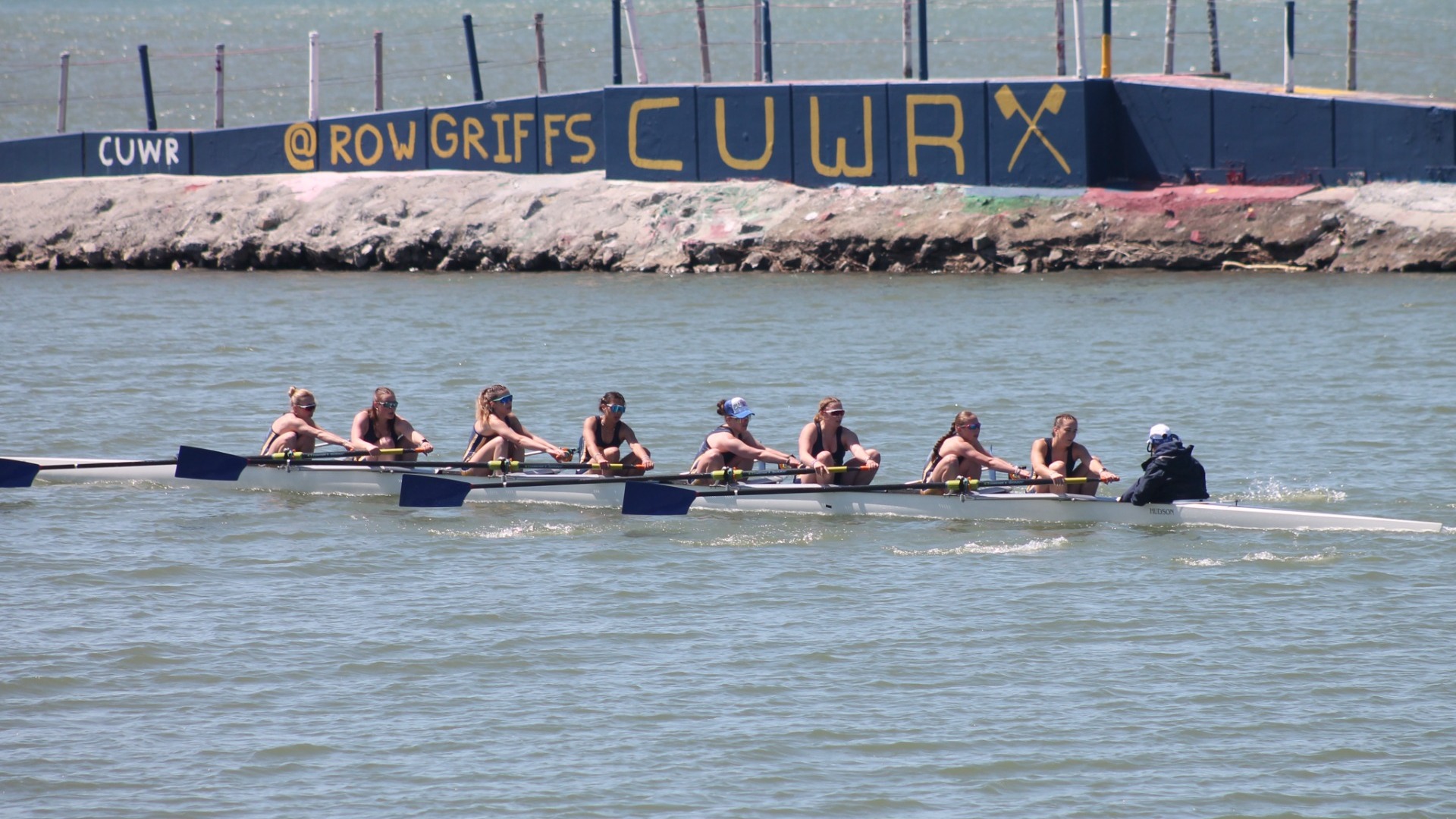 Varsity 8 boat races to the finish line at the Black Rock Cup on the Niagara River in Buffalo, N.Y.