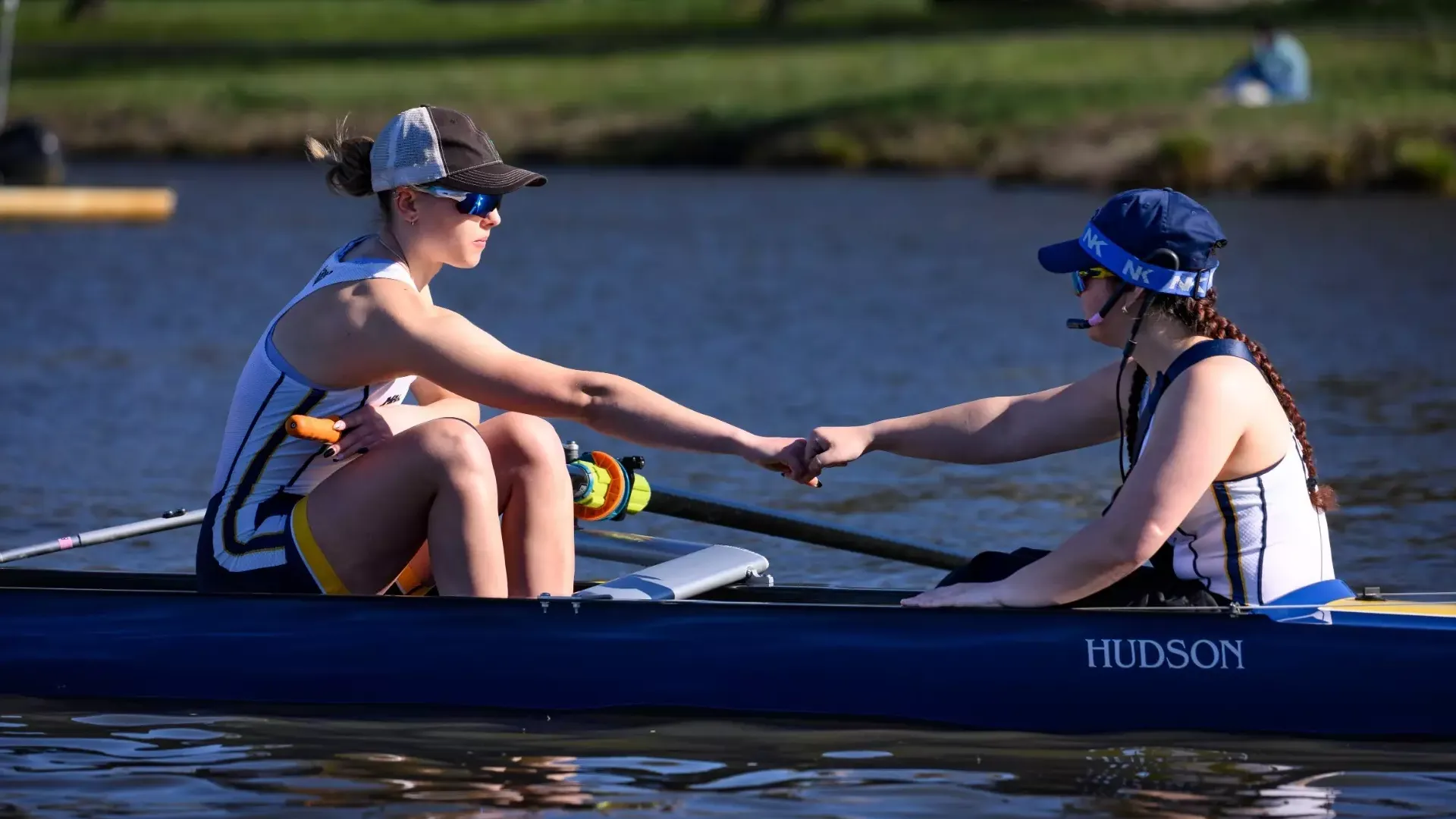 Rowing team fist bumps after a race at the Knecht Cup in Cherry Hill, N.J.