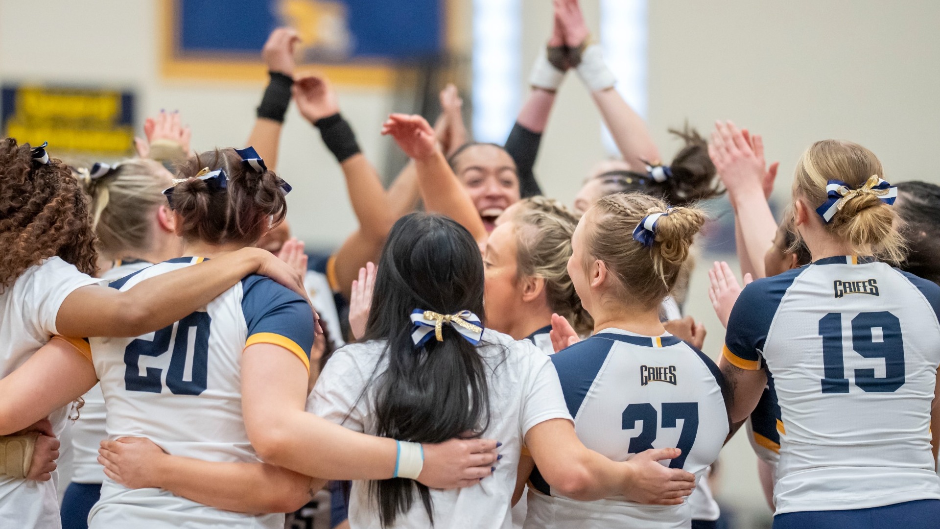 Acrobatics and Tumbling team celebrates after a win against Buffalo State