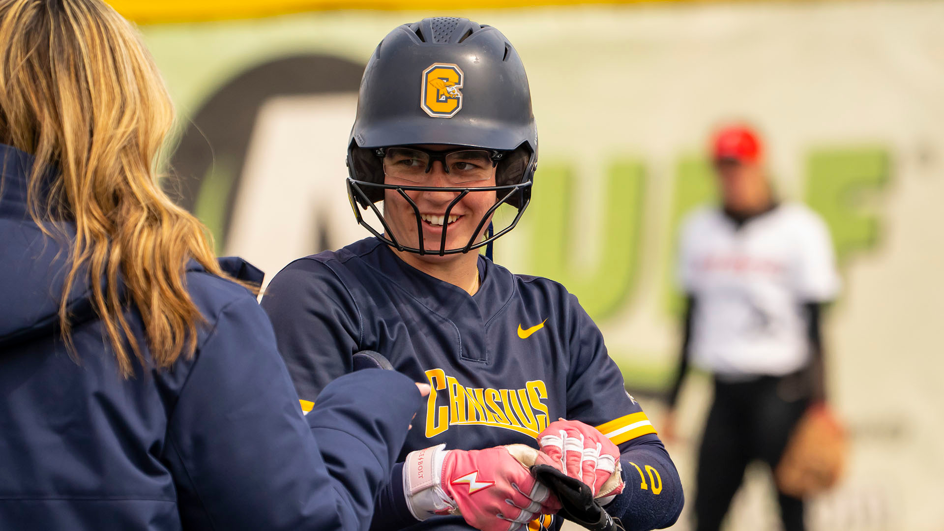 Ella Johel smiles and puts on her sliding mitt after reaching first with a base hit against Fairfield on March 29, 2026.