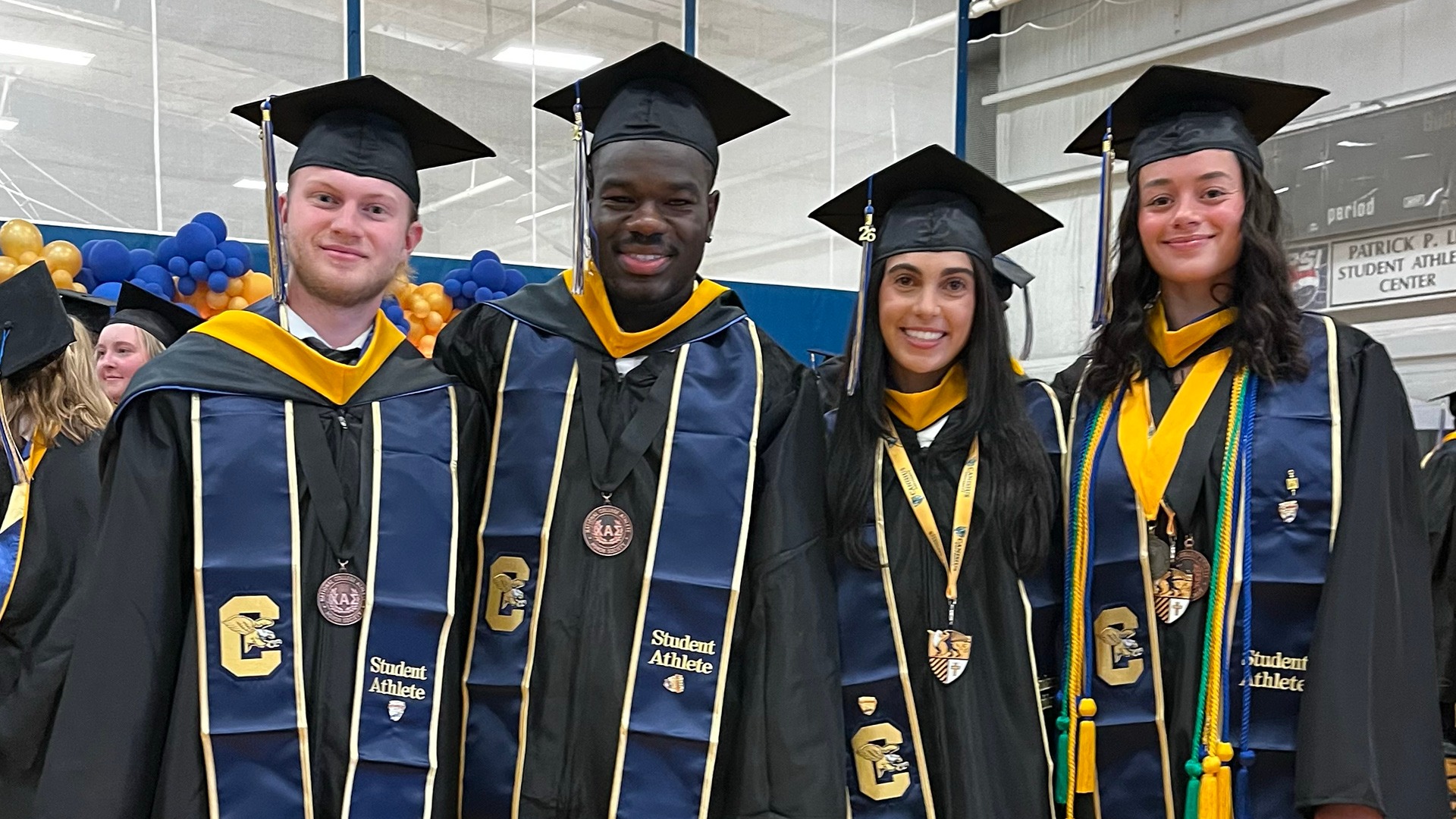 Canisius soccer players (left to right) Mason Wolford, Josh Miller, Mia Iacona and Lizzy Harkness are shown posing in cap and gown following spring graduation ceremonies at the Koessler Athletic Center