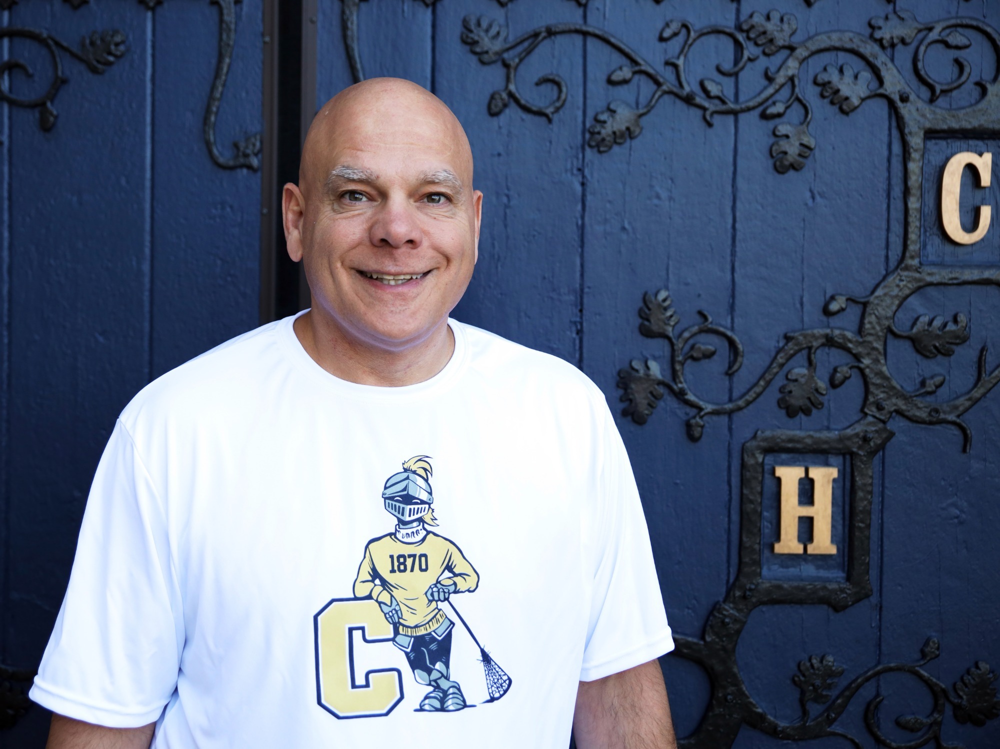Lacrosse coach Pat Mete in front of the Blue Doors 