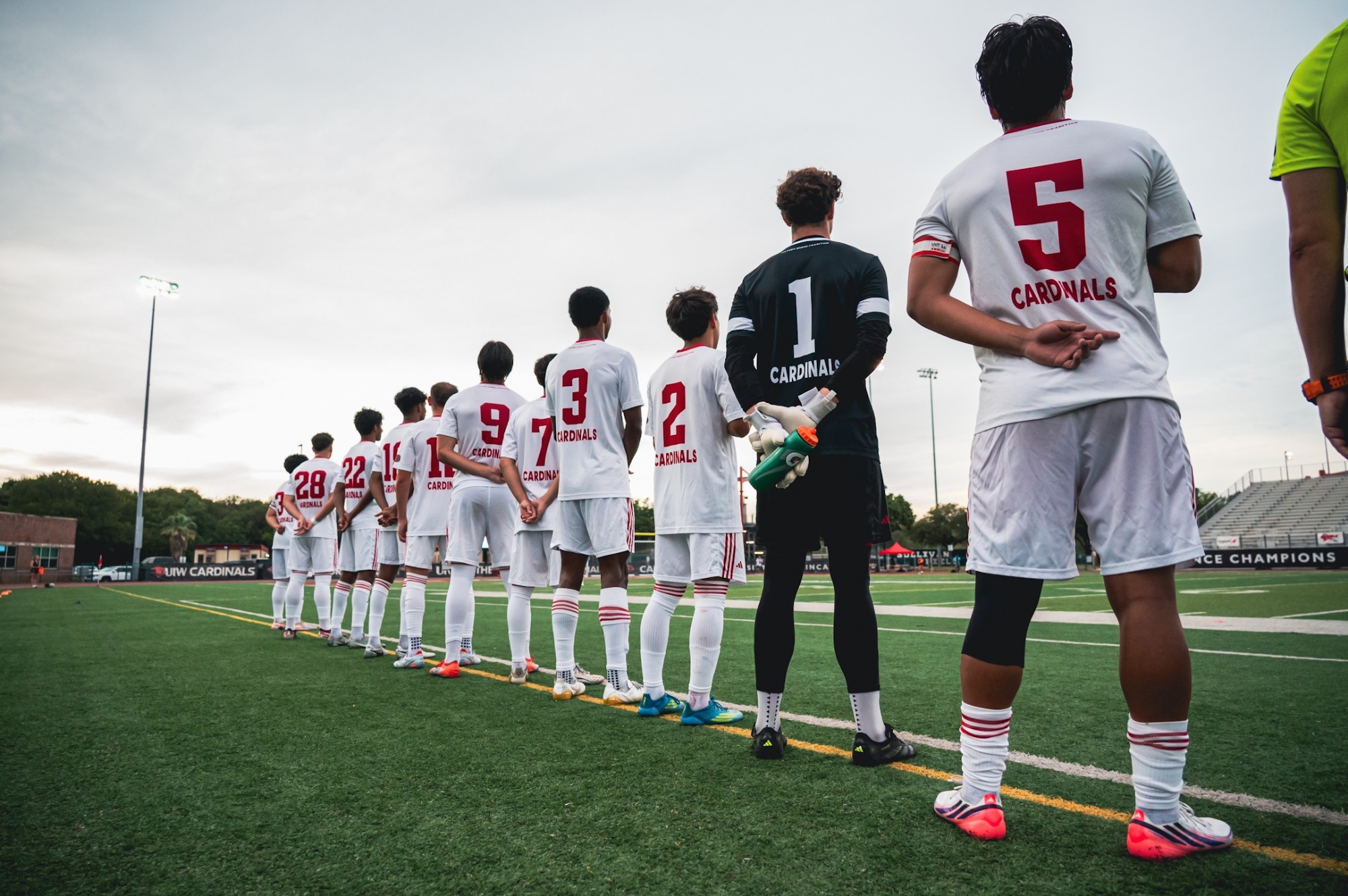 Men's soccer stands for national anthem