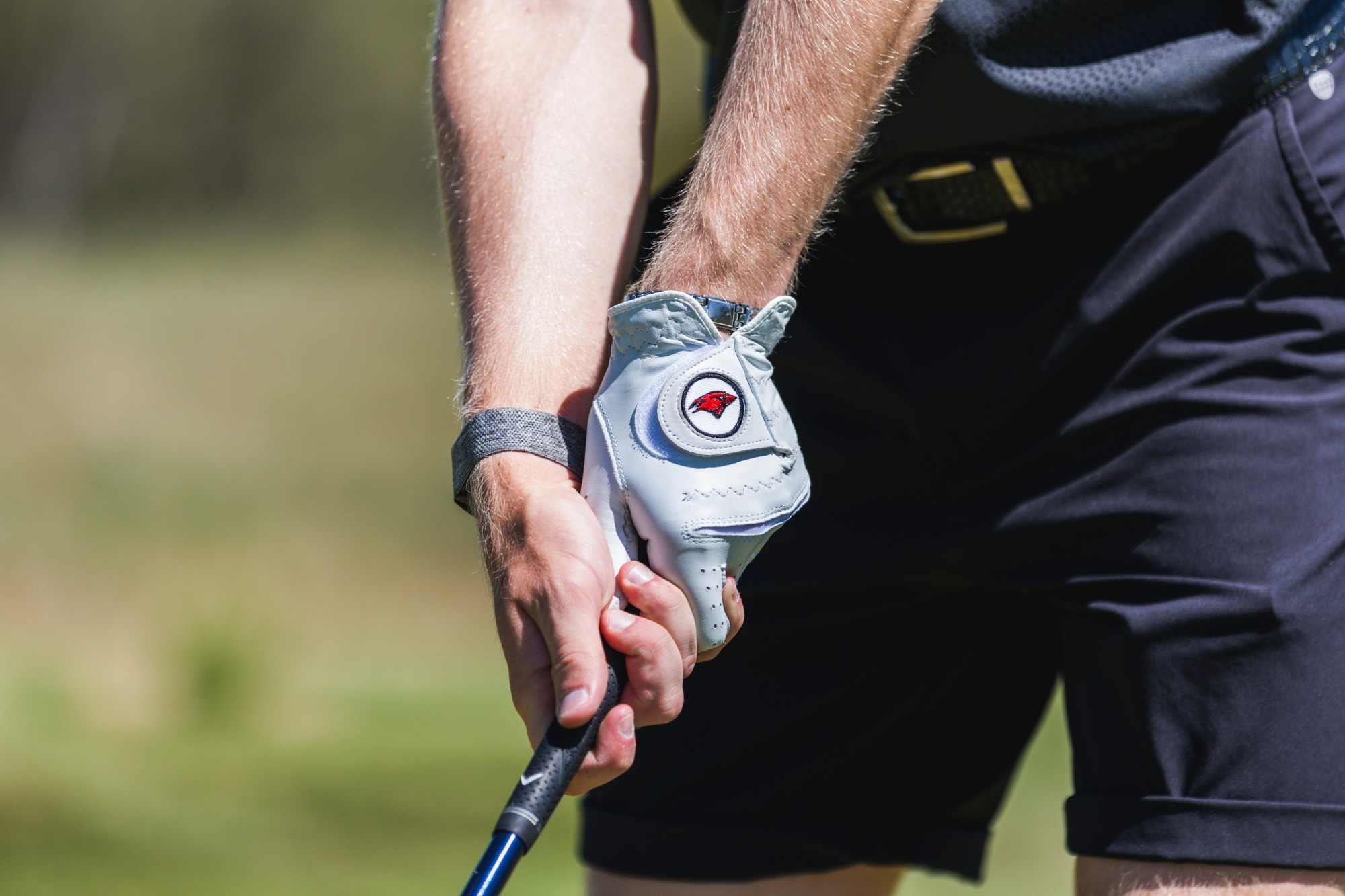 A player from the men's golf team hold a club