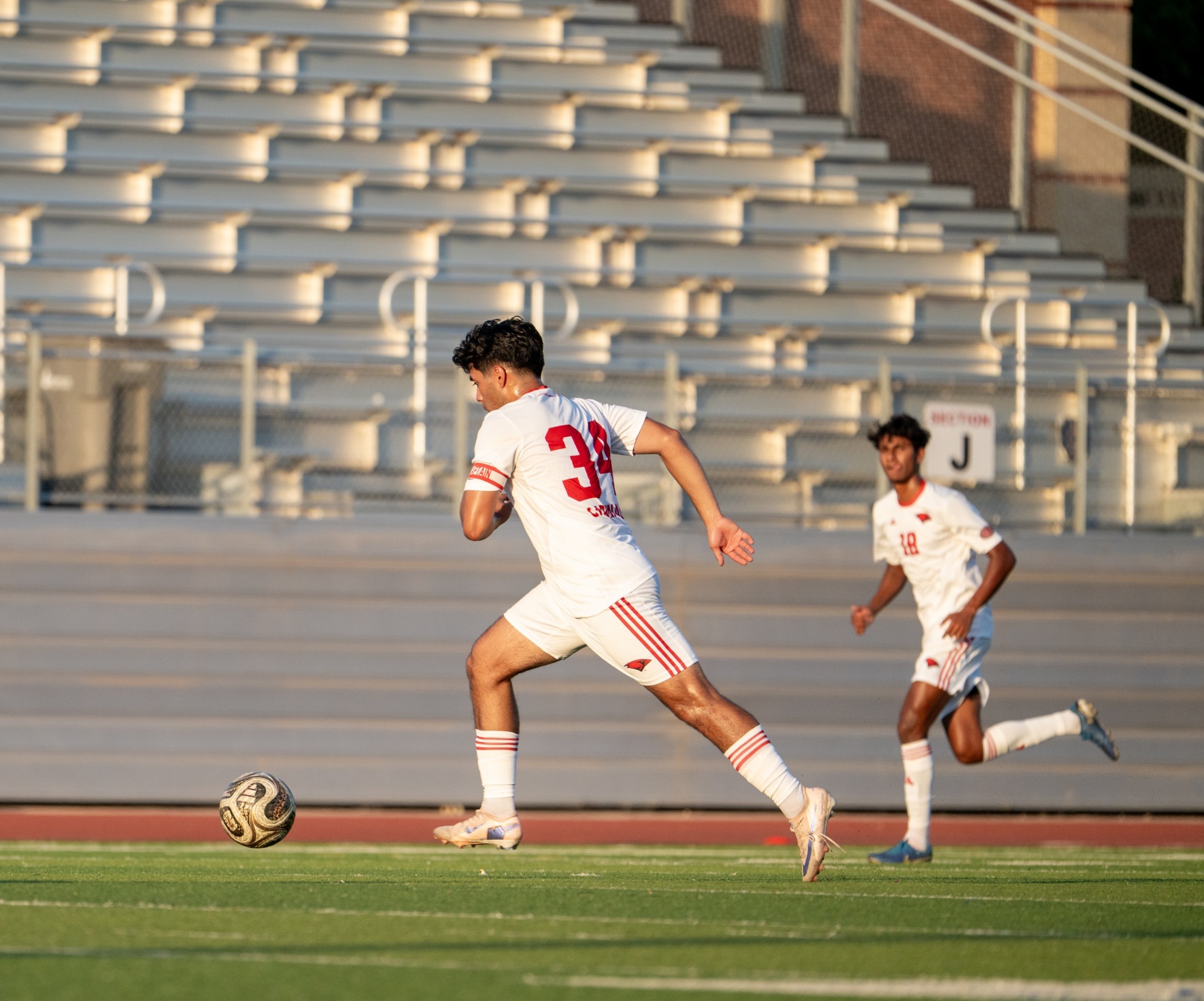 Padilla kicking a soccer ball in UIW's match with Jacksonville