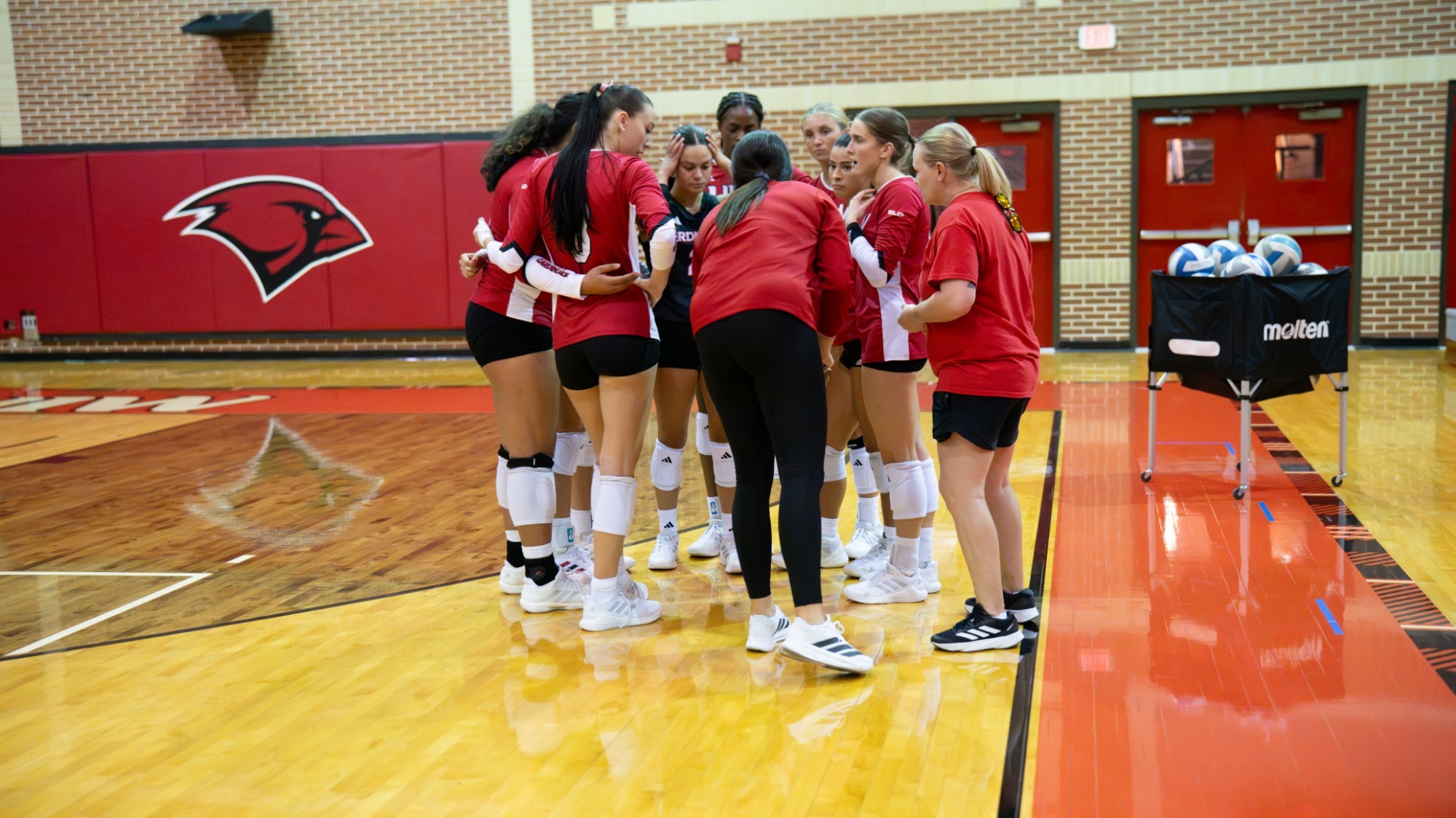 Volleyball huddles at the scrimmage