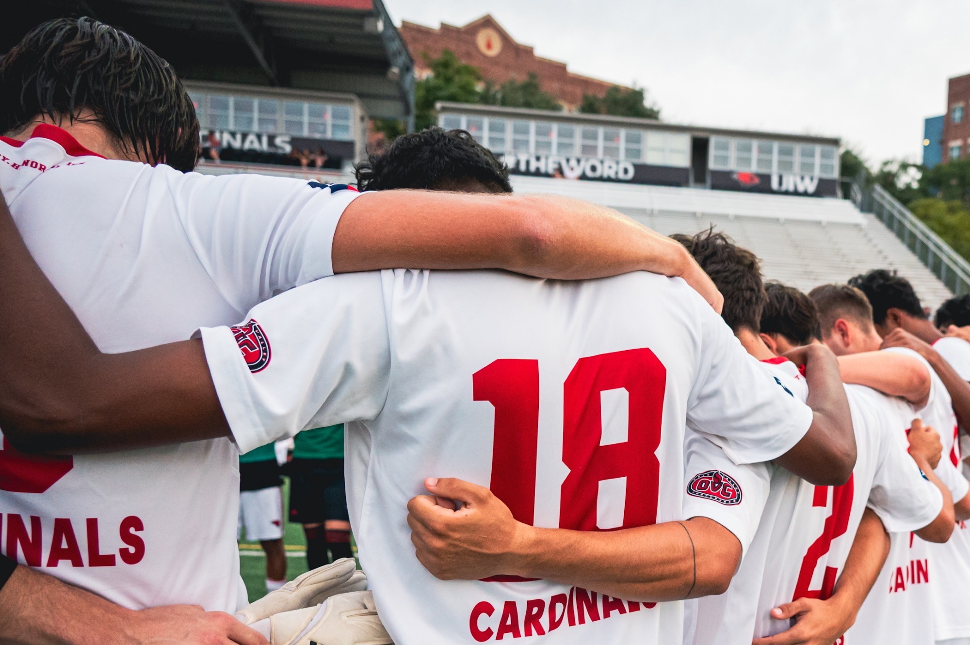 Men's soccer huddles