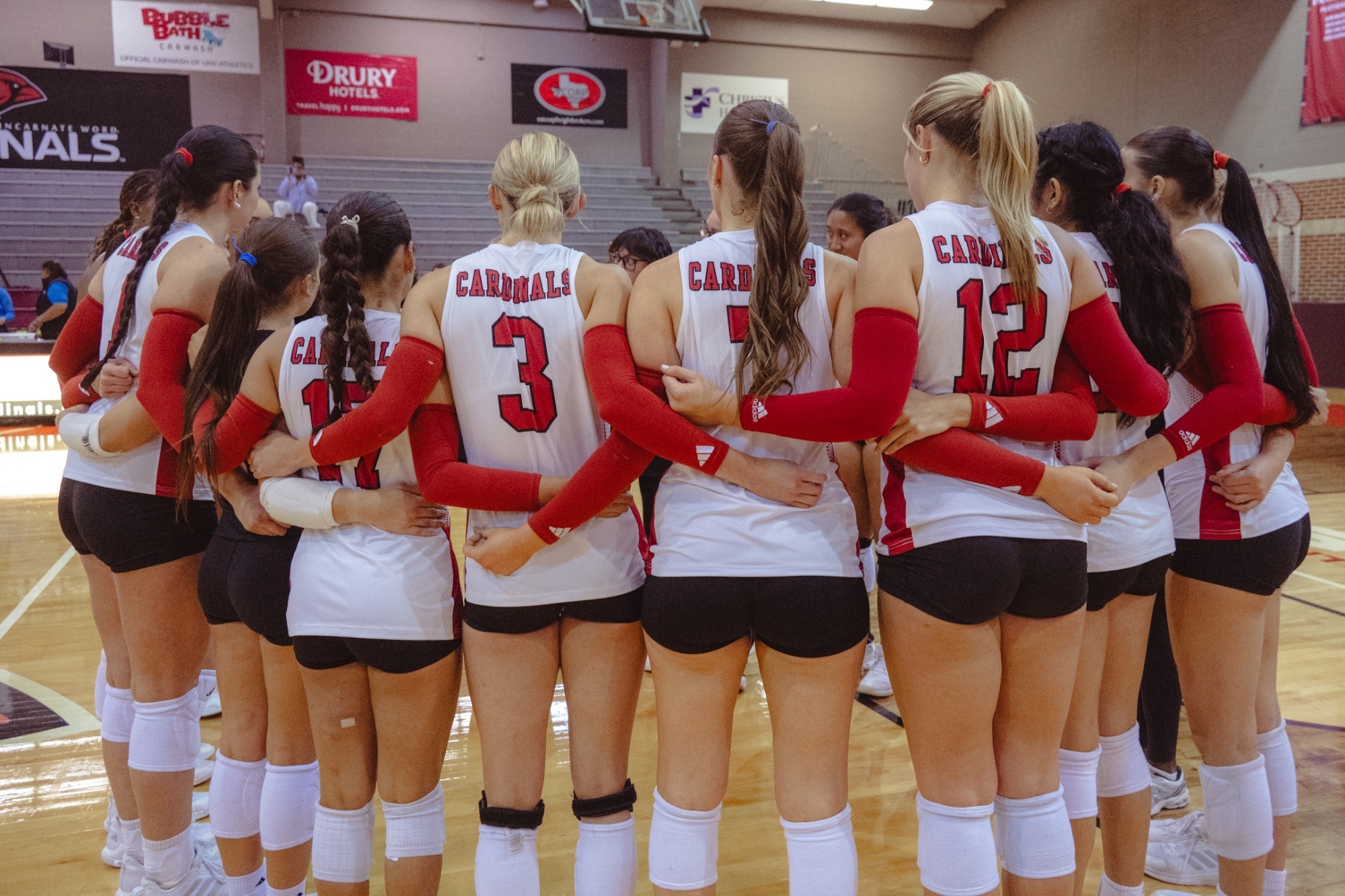 Volleyball huddles at home against Tarleton St.