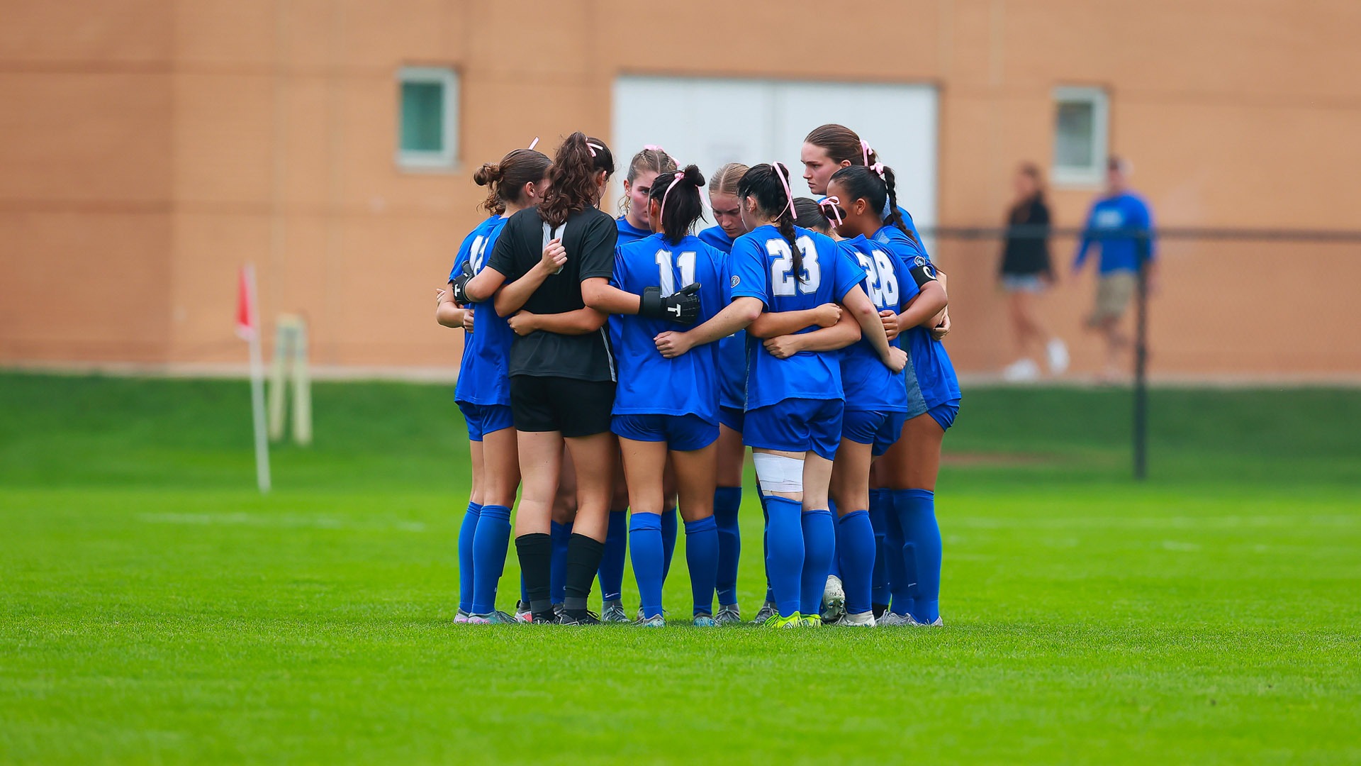 CWRU women's soccer team in a huddle during a game against Chicago in 2025