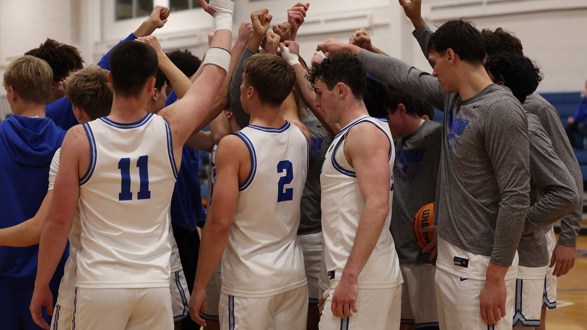 The Spartans huddling before their game against Houghton