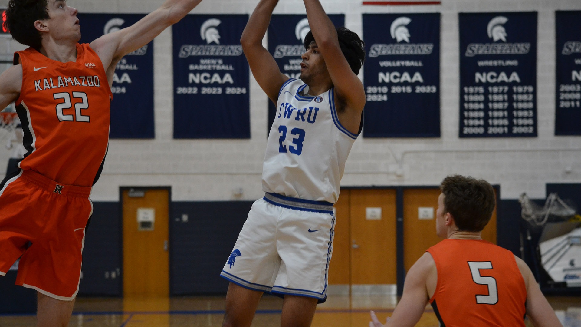 Anand Dharmarajan shooting a three against Kalamazoo