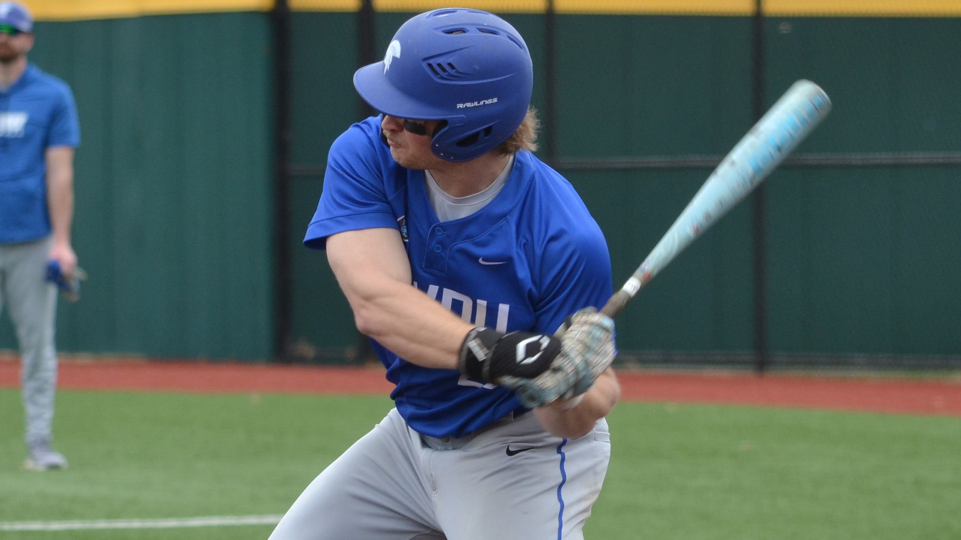 Nick Harms swinging at a pitch against Johnson and Wales