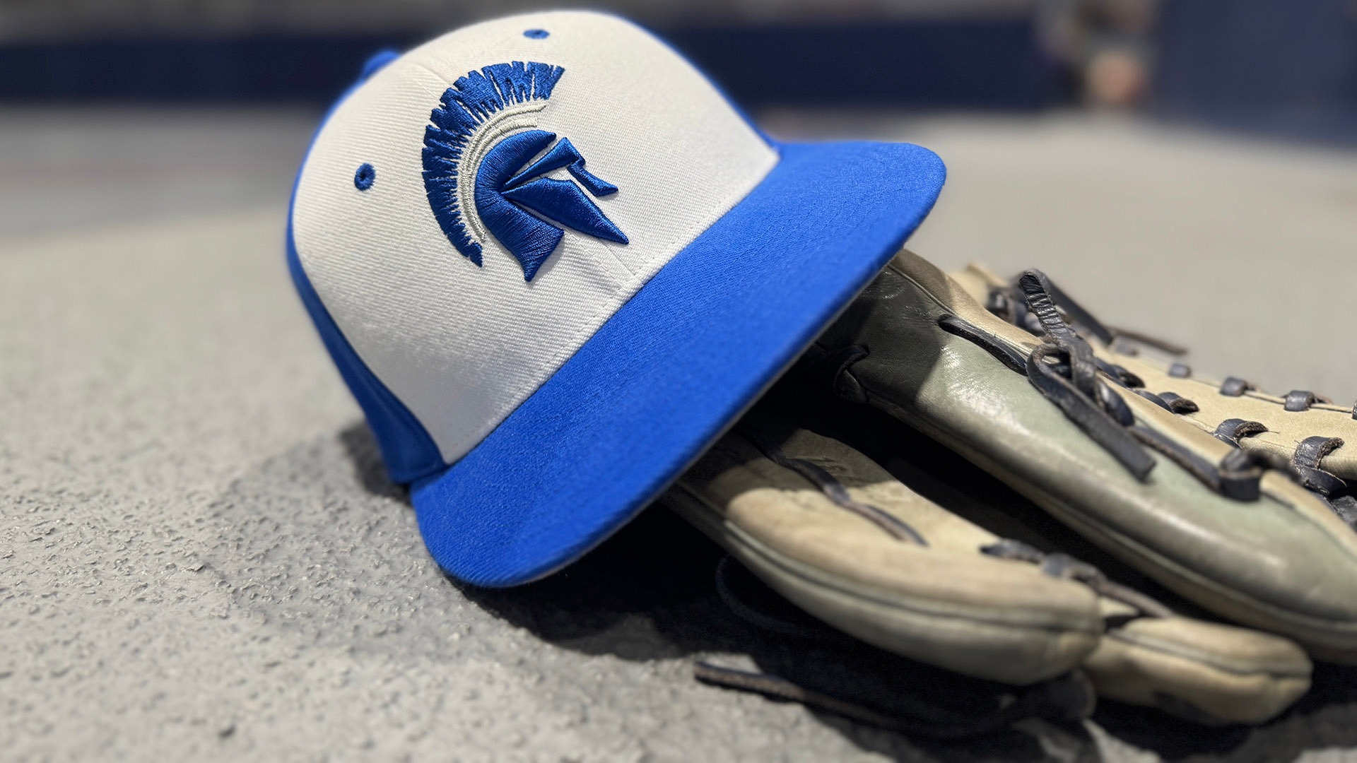 A CWRU baseball hat on a baseball glove