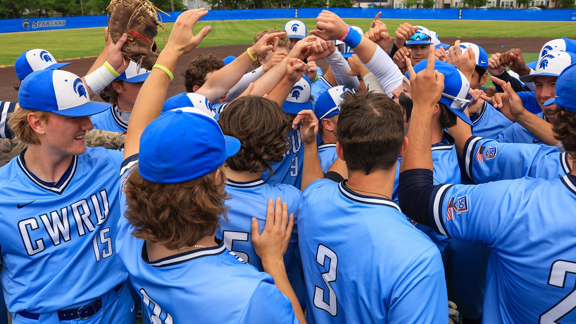 The CWRU baseball team huddles after winning the NCAA Regional