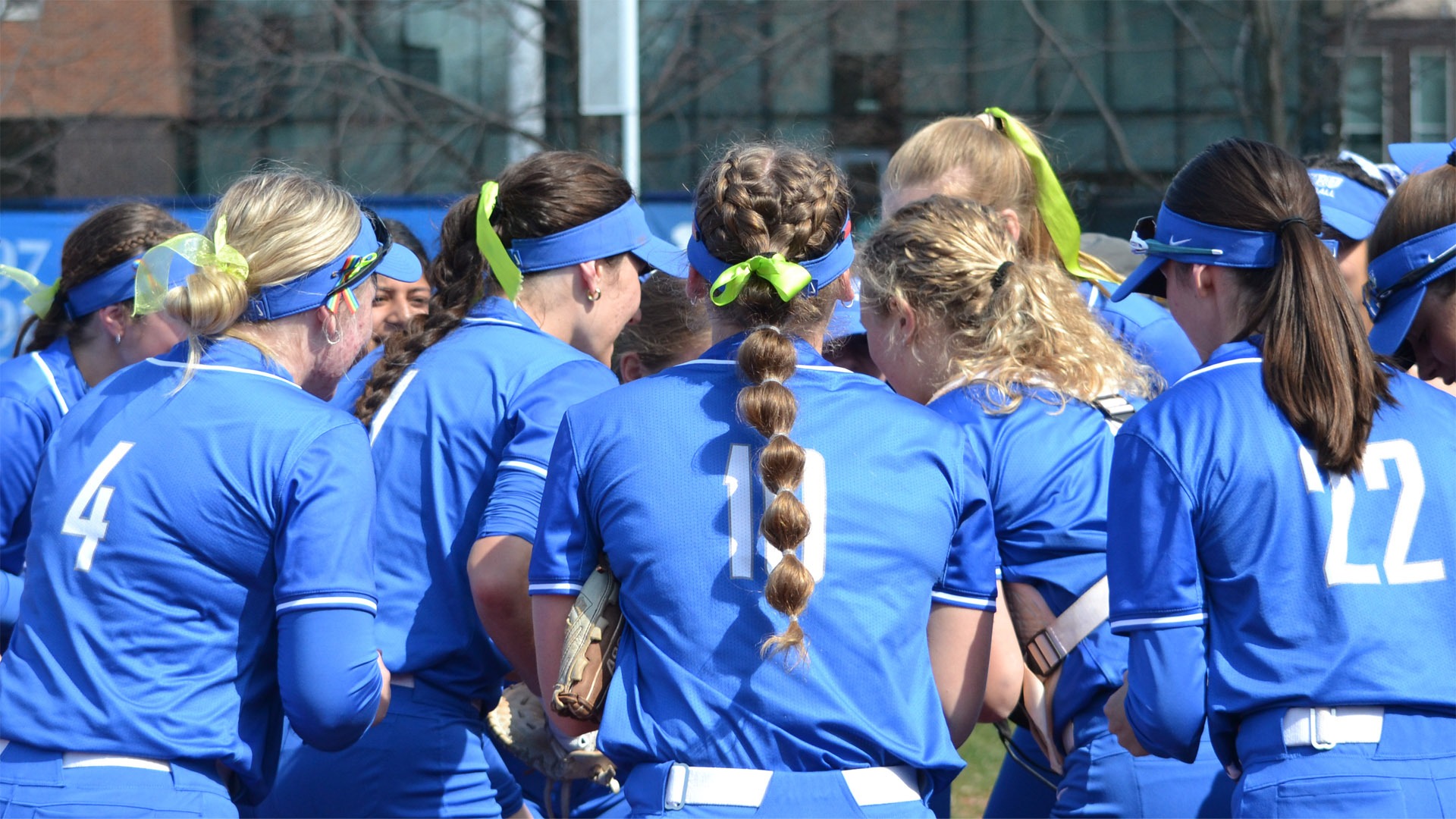 CWRU softball team in a huddle prior to the game against Capital