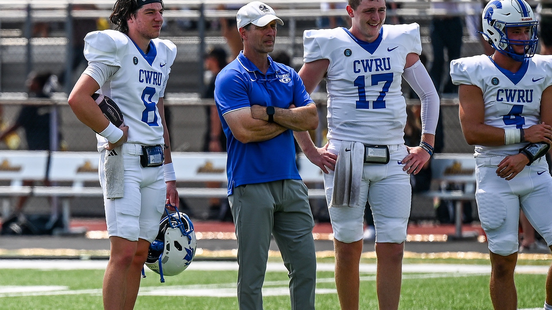 Greg Debeljak standing with the CWRU quarterbacks