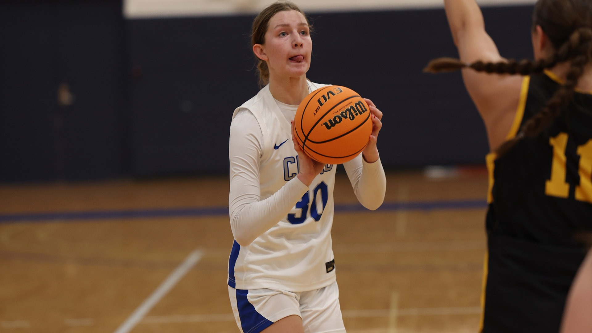 Maura Schorr shooting a jump shot against Adrian