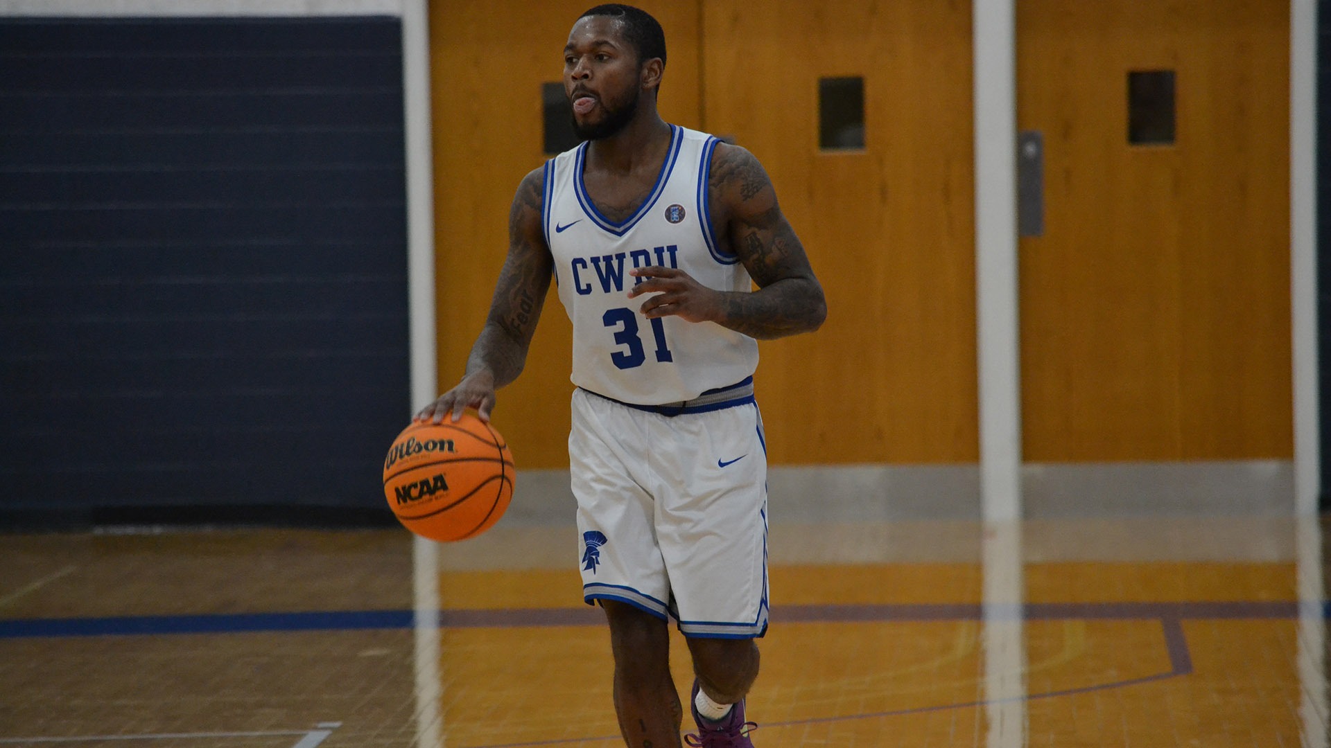 Ethan Edwards dribbling the ball up the court against Kalamazoo