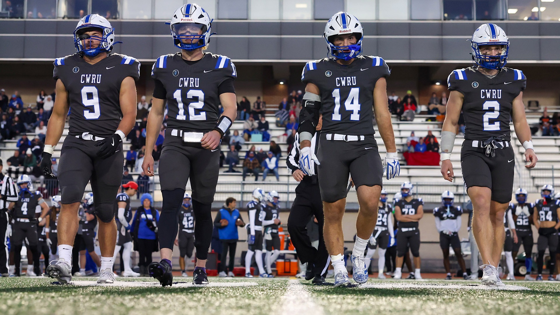 The CWRU football captains walking out for the coin toss against Waynesburg