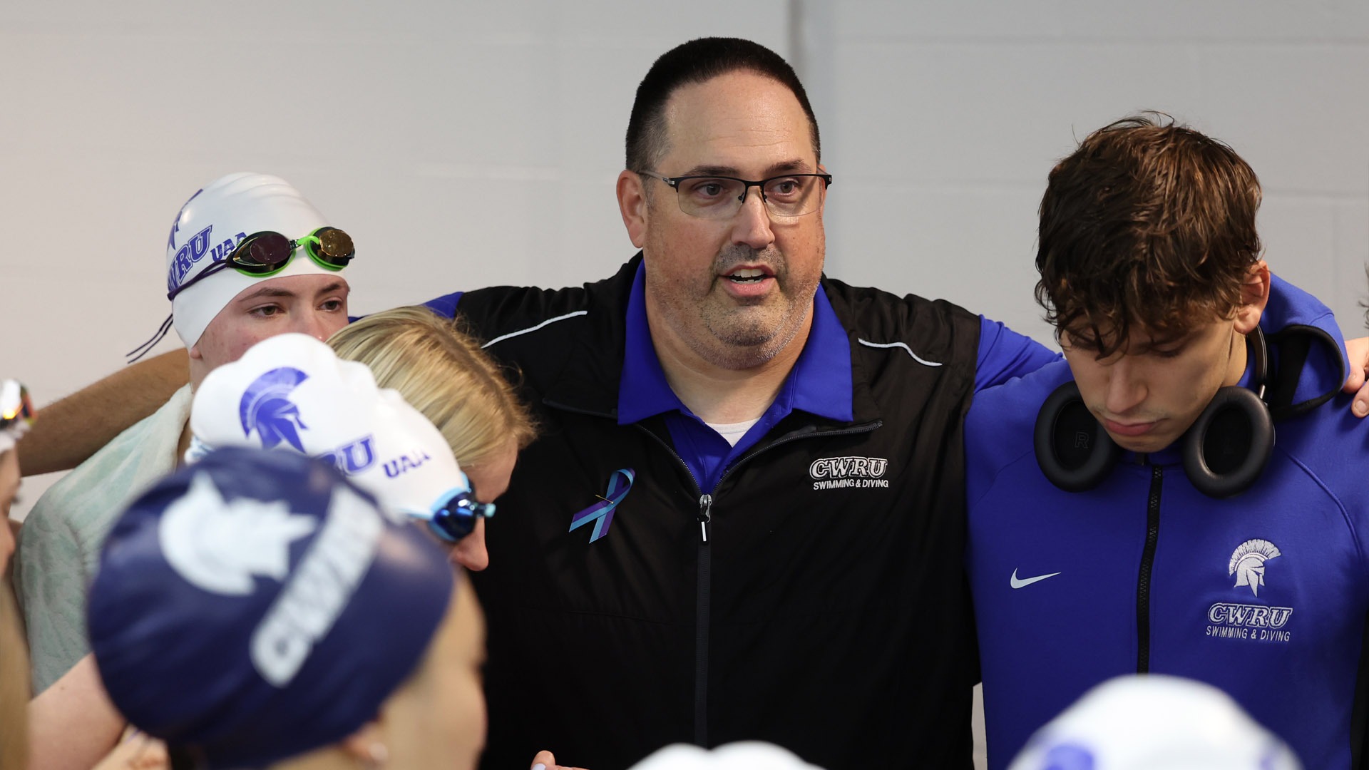 Doug Milliken addressing the swim dive teams ahead of a meet in 2025