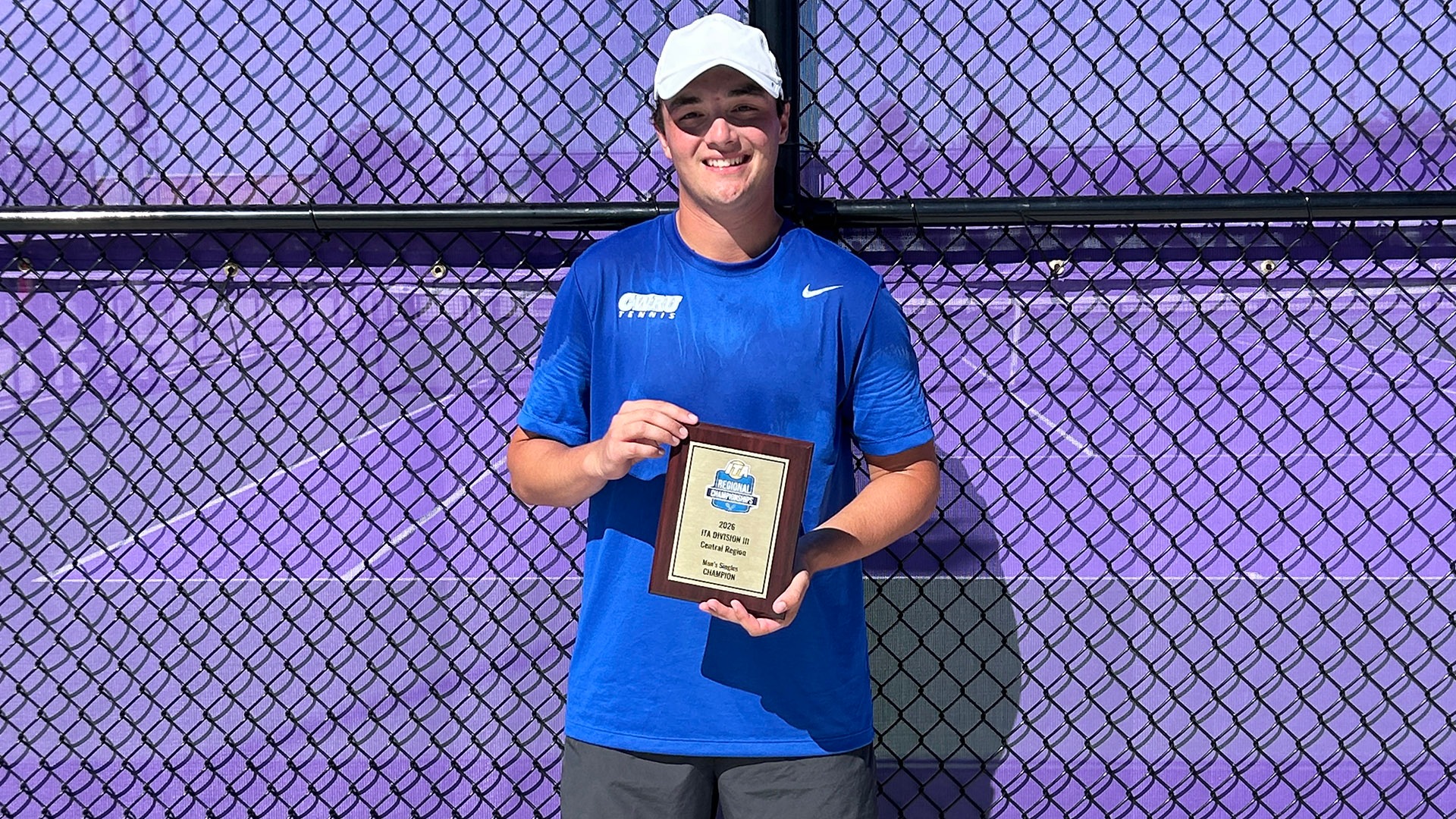 Rowan Matorin holds his plaque after winning the ITA Regional Singles Title