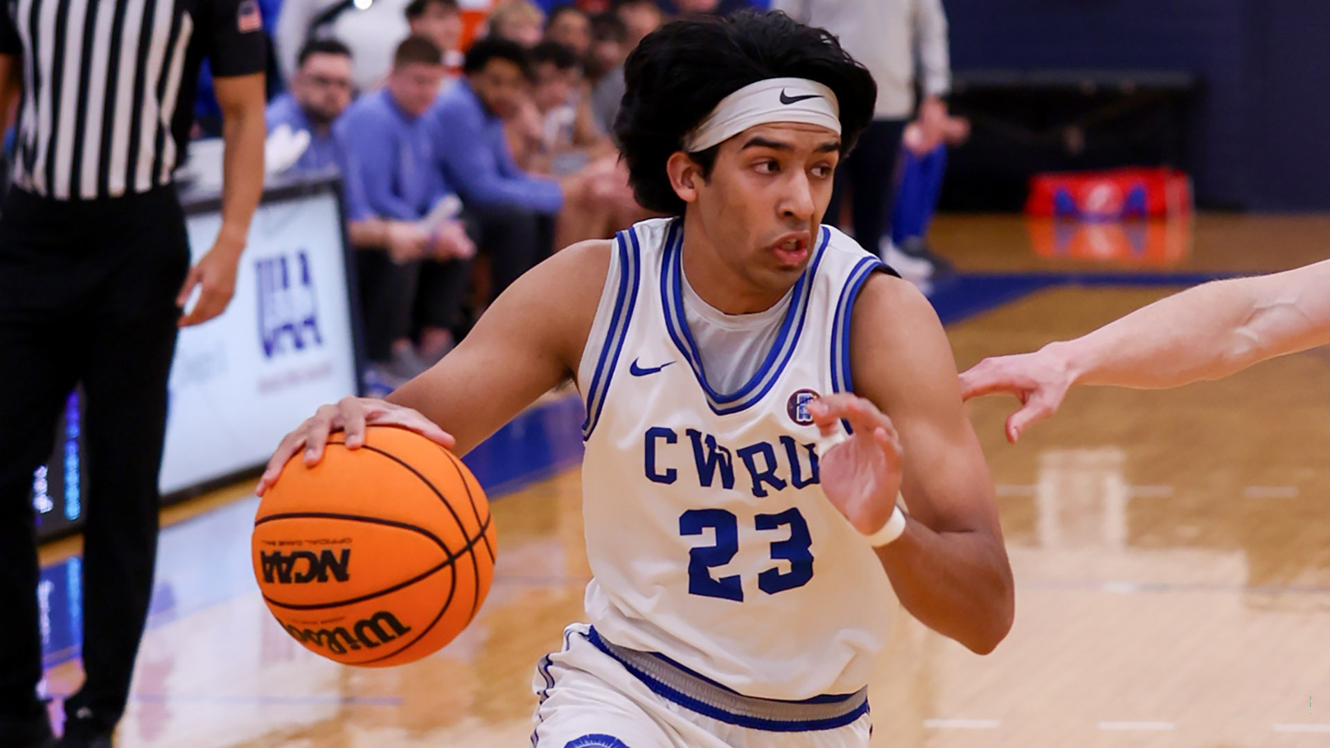 Anand Dharmarajan driving to the hoop against UChicago