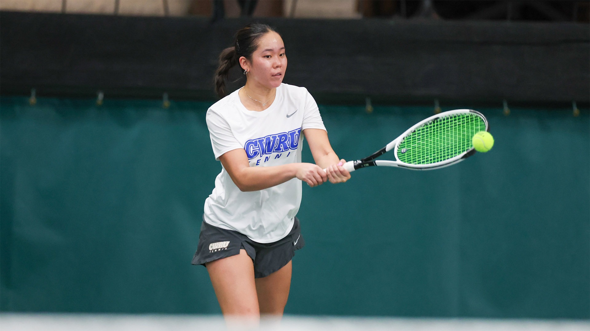 Katie Wong hitting a backhanded shot in 2025