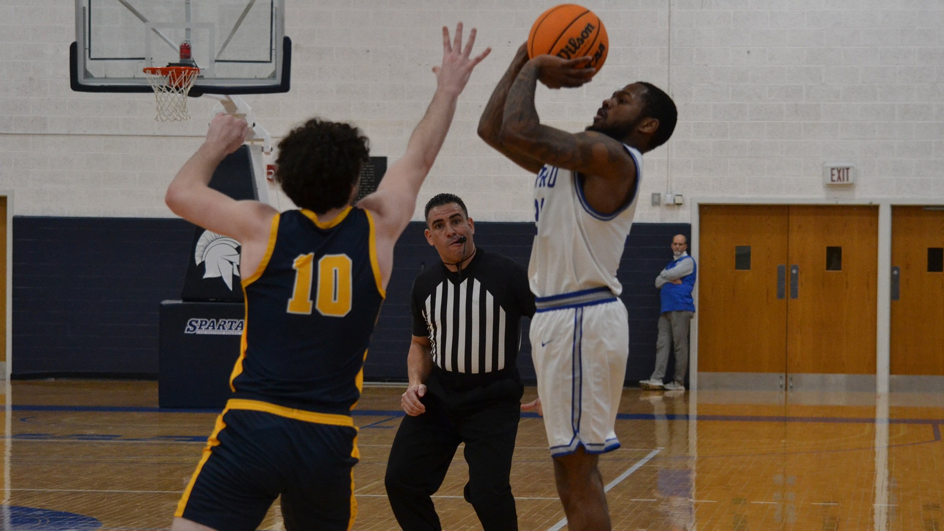 Ethan Edwards taking a three-point shot against Rochester