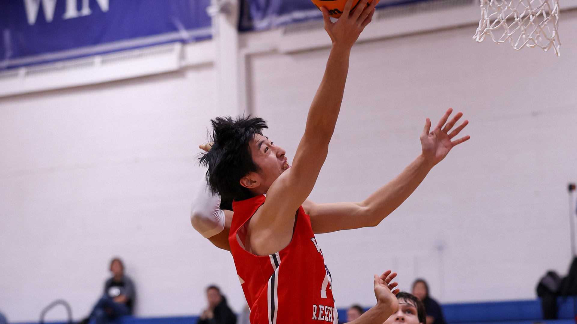 Luca Asanaka attempts a layup against NYU