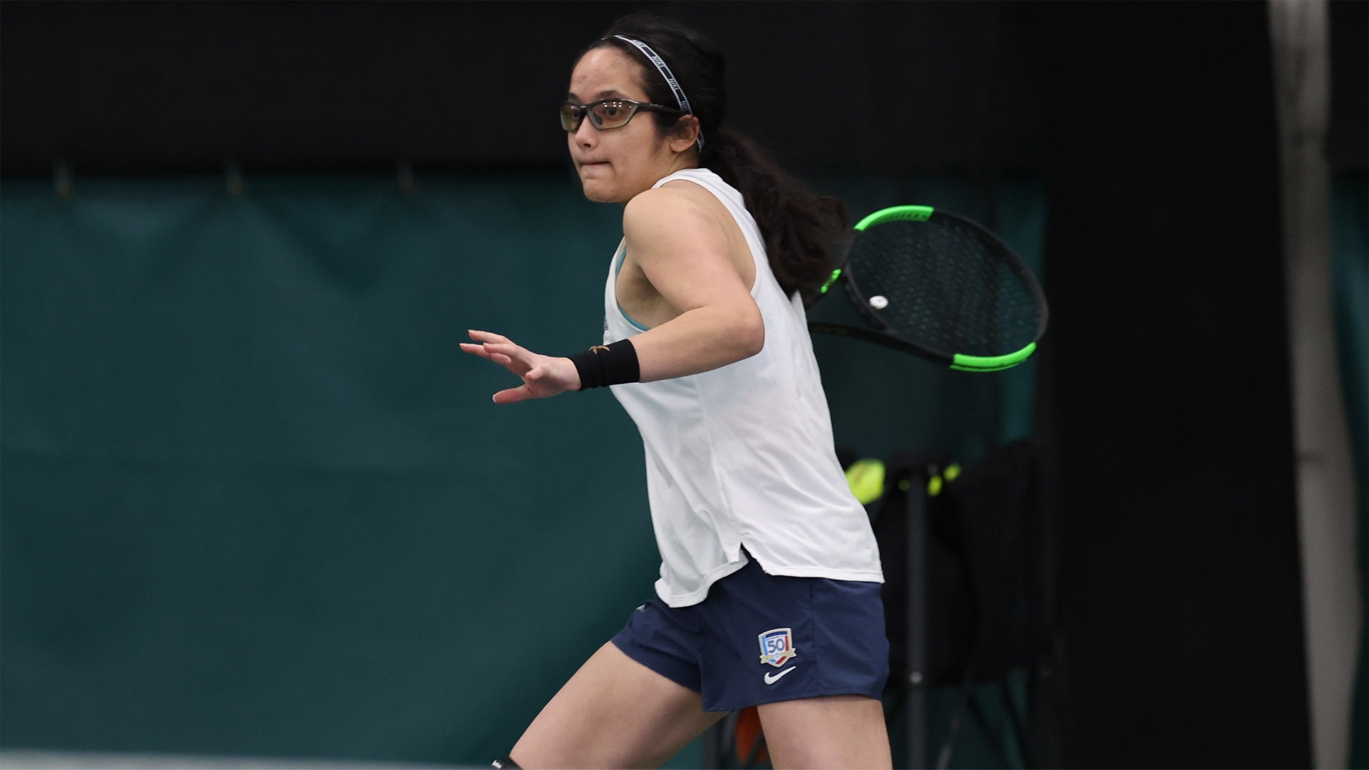 Hannah Kassaie about to hit a forehanded shot against Denison