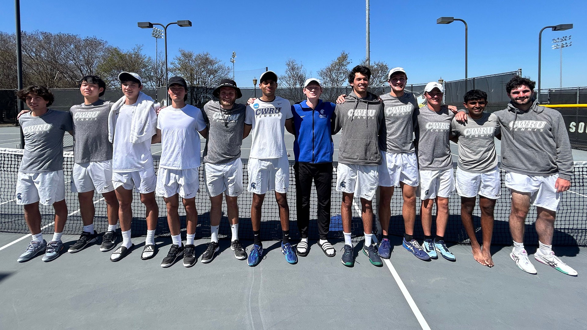 The CWRU men's tennis team posing on the Southwestern courts