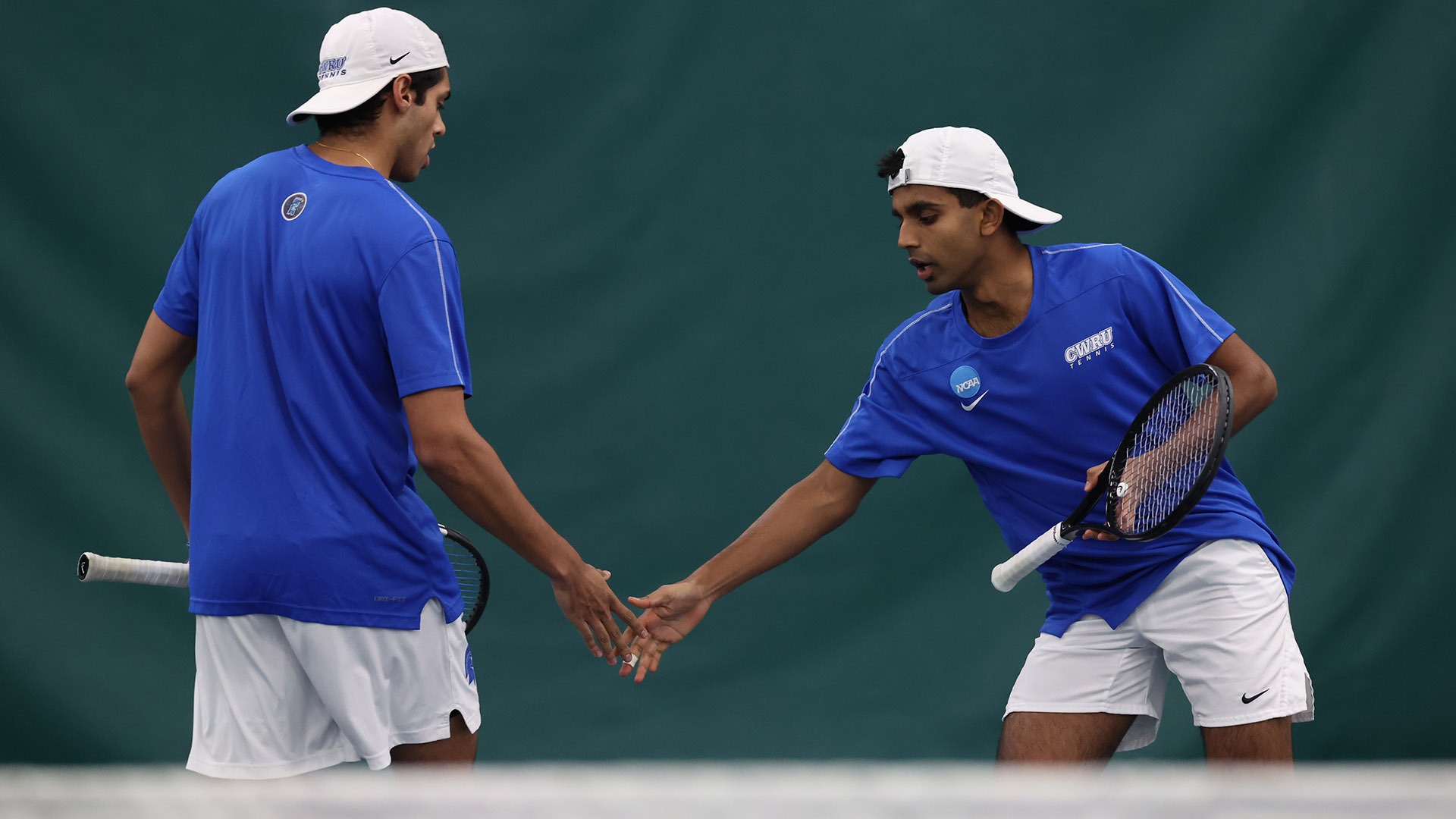 Rohan Bhat and Anmay Devaraj shaking hands after a point