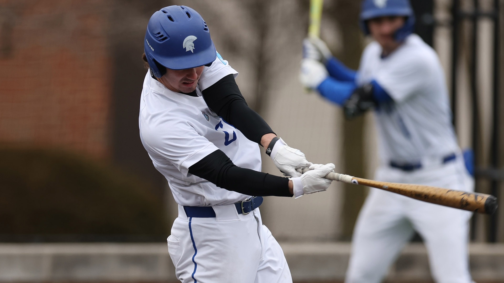 Eli Westrick hitting the ball against Oswego