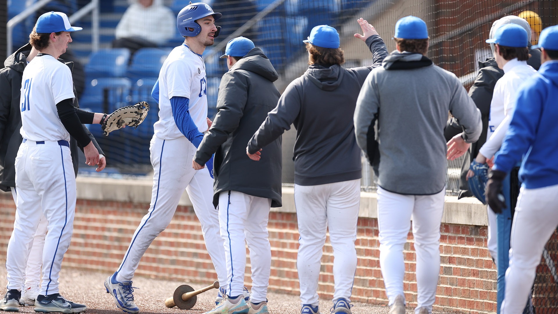 Tyler Stillson getting congratulated heading into the dugout
