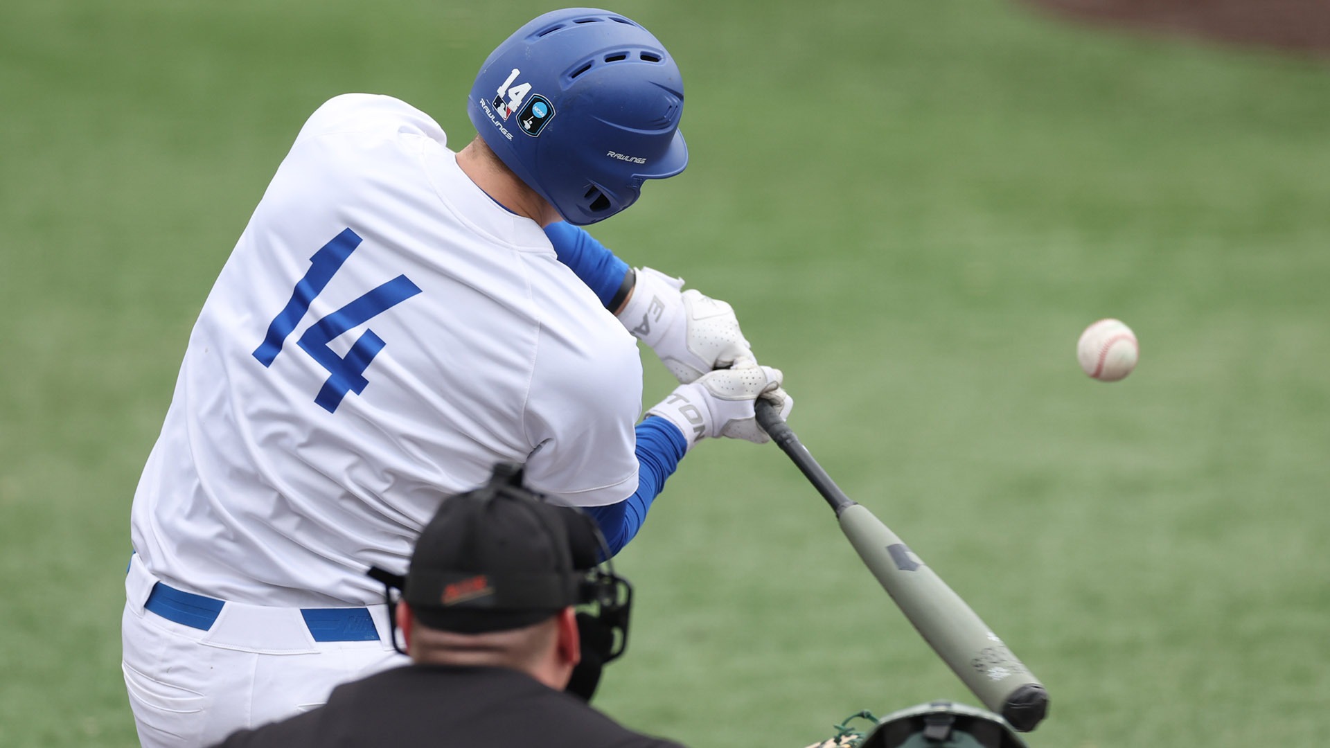 A photo of Matt Trout hitting the ball from behind