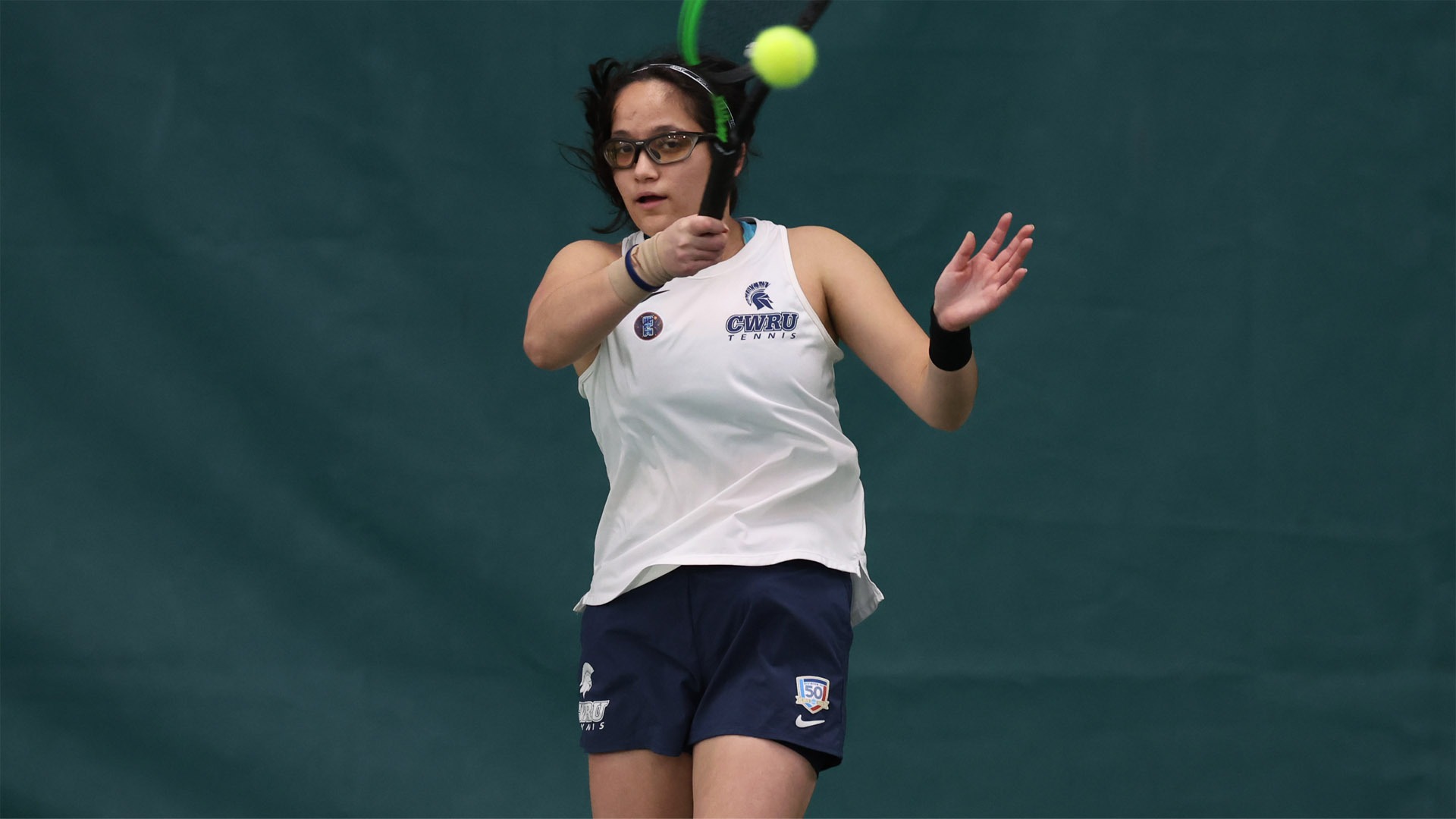 Hannah Kassaie on the follow through of a forehanded shot