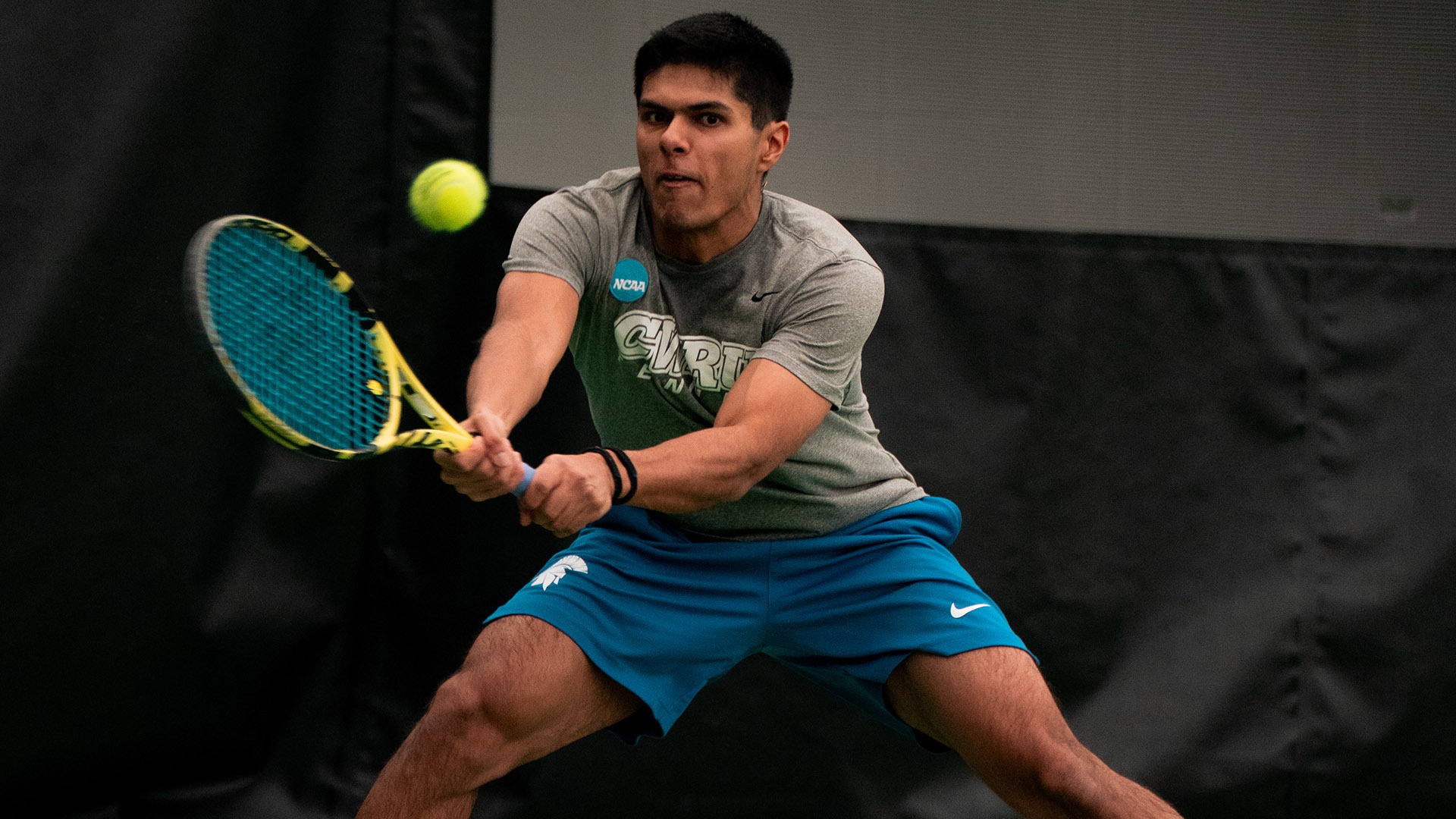 Ansh Shah hitting a forehand shot against JHU