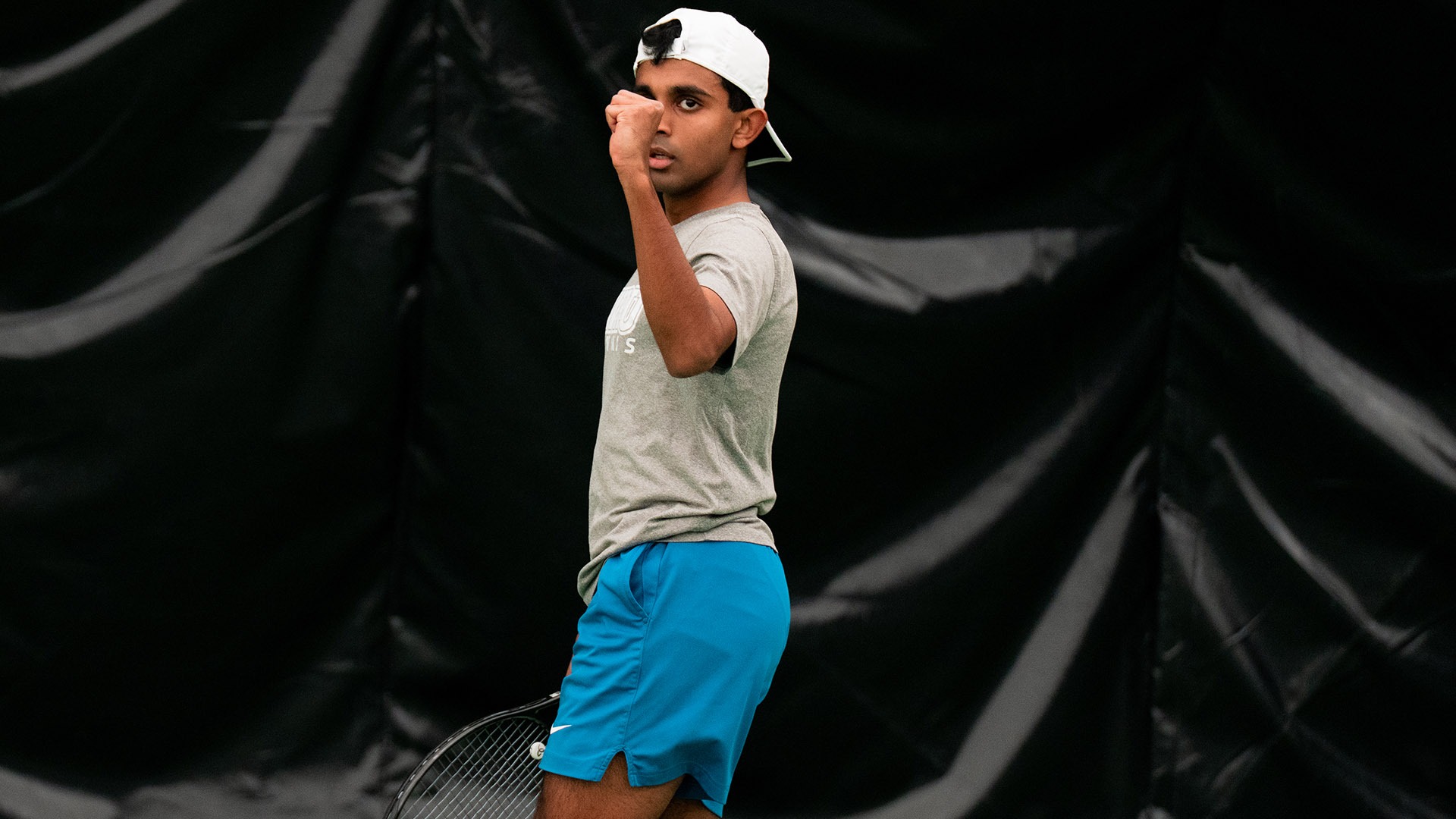 Anmay Devaraj fist pumps after scoring a point