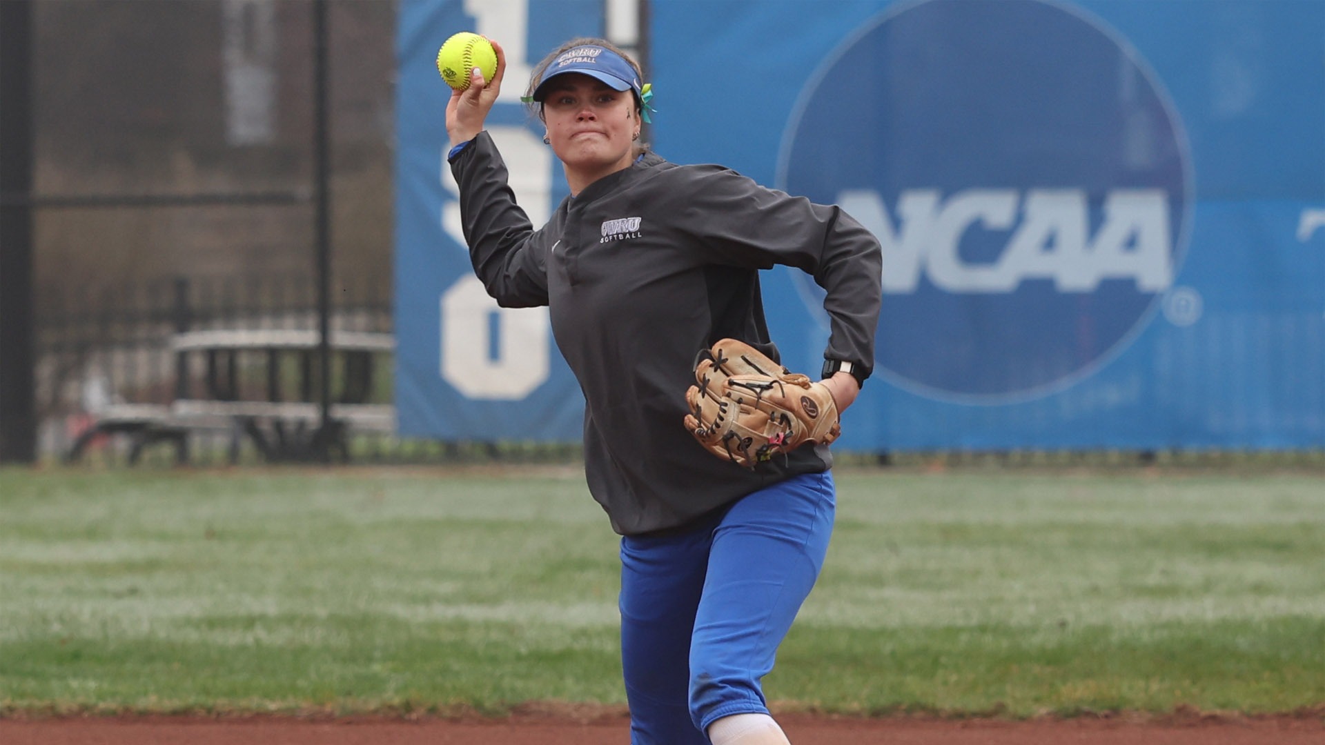 Karen Potts throwing the softball to first base