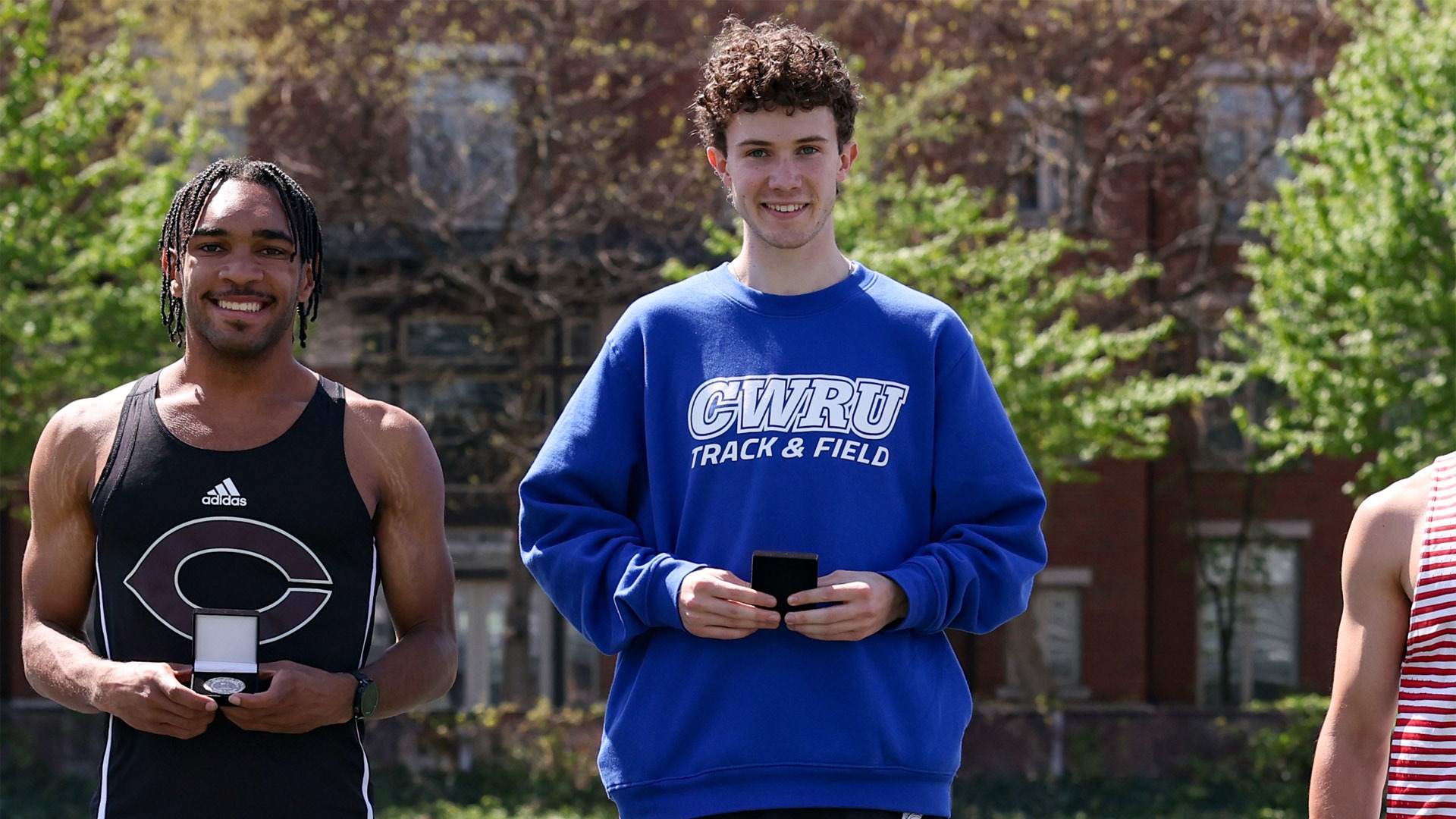 Donovan Crowley standing atop the UAA Outdoor podium for the 1,500-meter run