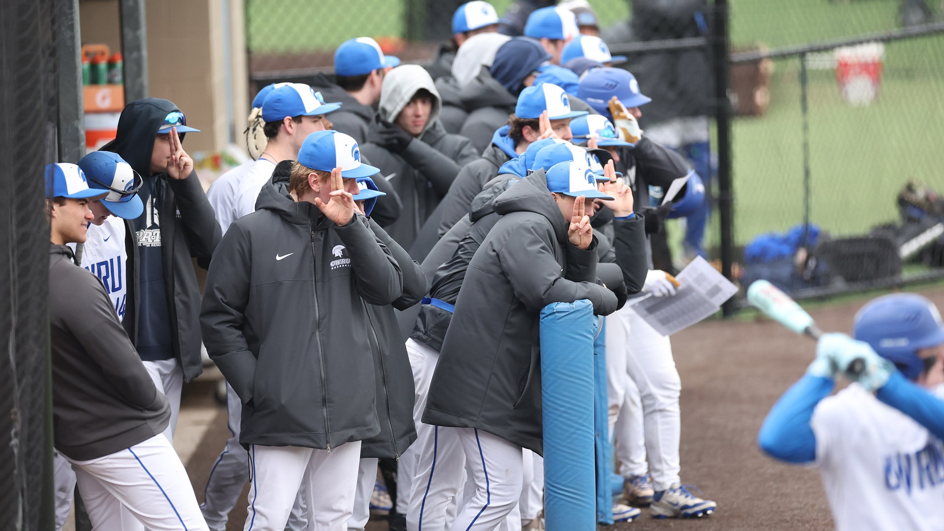 The Spartans in the dugout against SUNY Oswego
