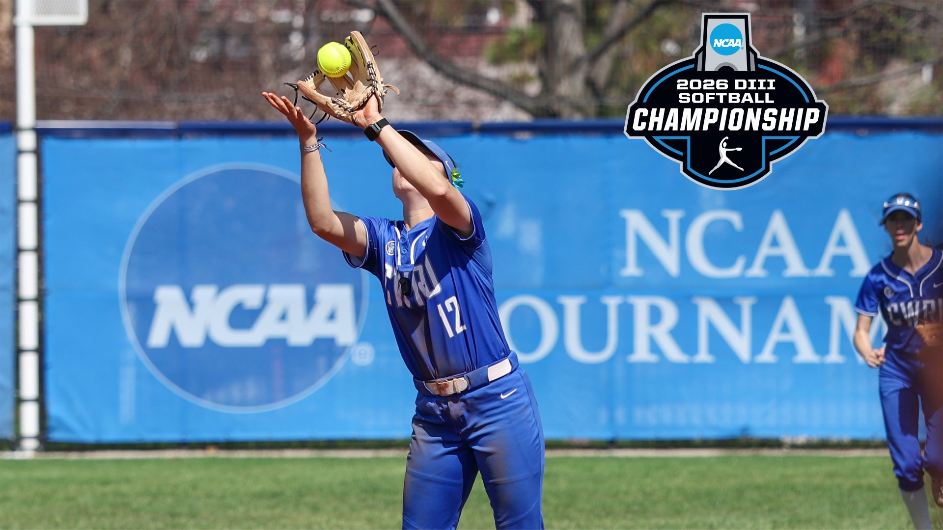 Karen Potts catching a popup in front of the NCAA Tournament banner with the 2026 NCAA Softball Championship logo in the top right corner