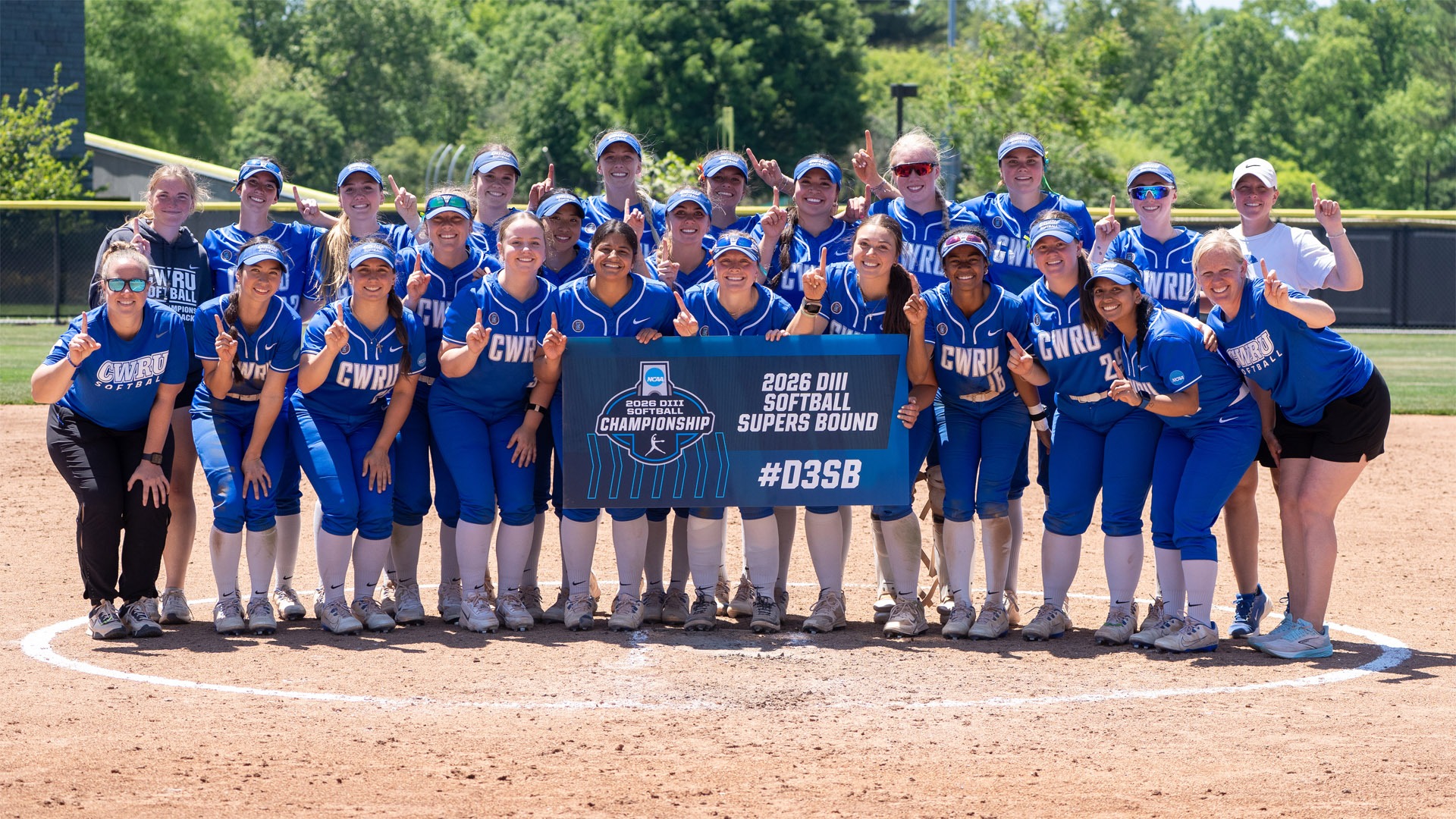 The 2026 CWRU Softball team posing with the NCAA Regional banner and holding one finger up