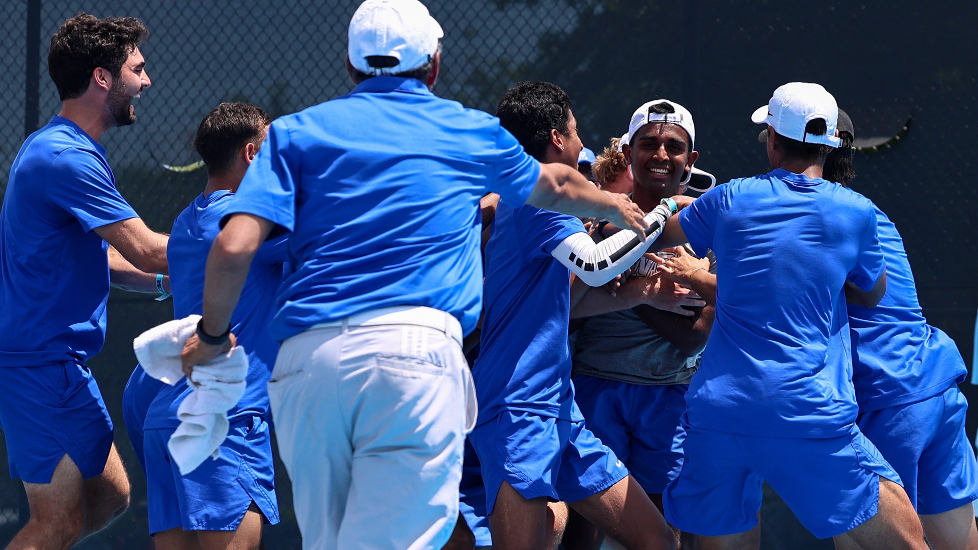 The CWRU men's tennis team celebrating after their win over Denison