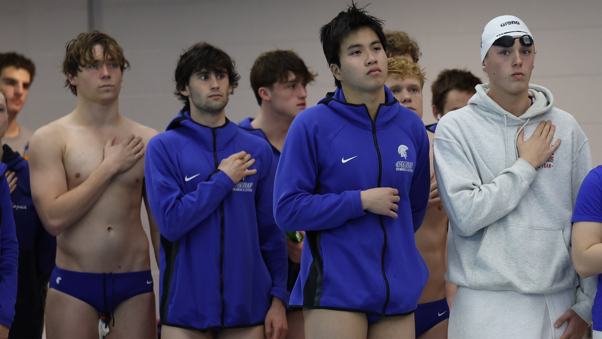 Members of the CWRU men's swimming and diving team standing for the national anthem